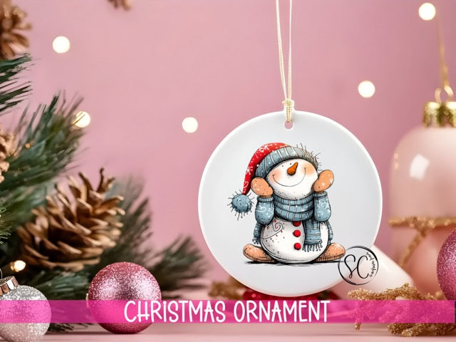 a snowman ornament hanging from a christmas tree