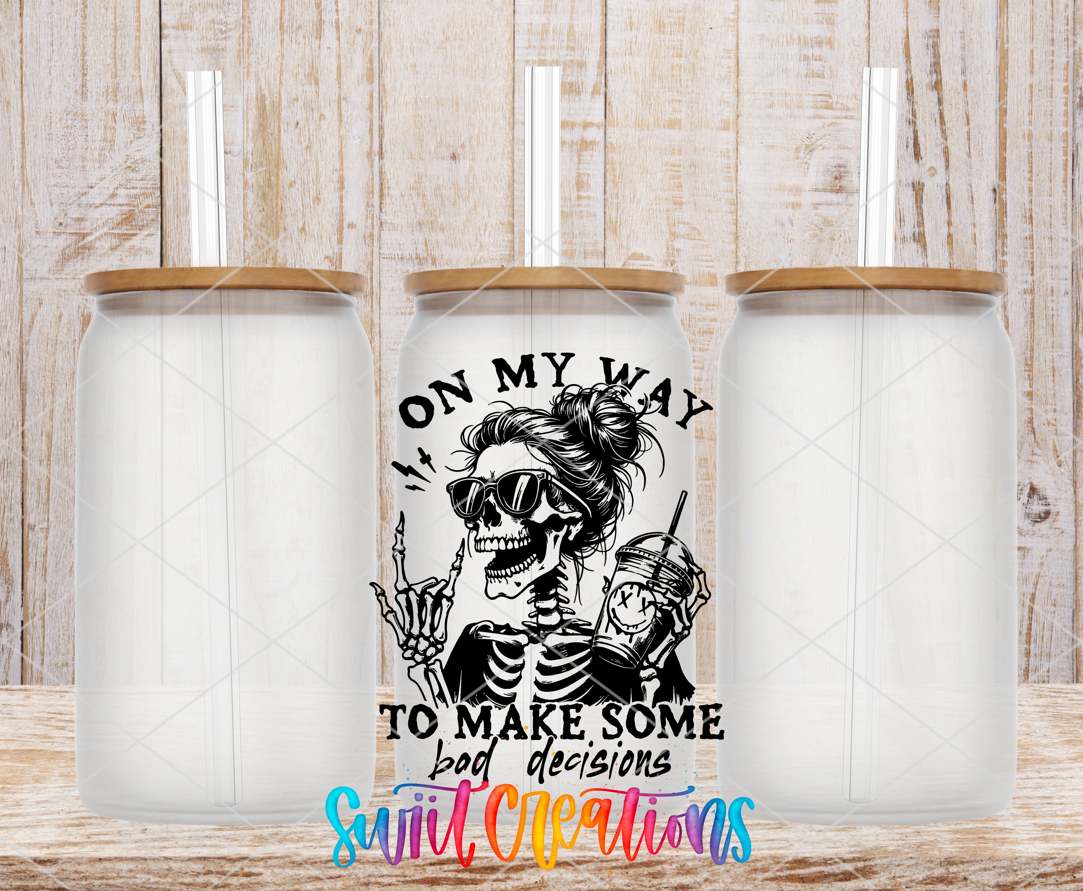 Swiit Creations UV DTF Making Bad Decisions transfer shown on a clear glass can set