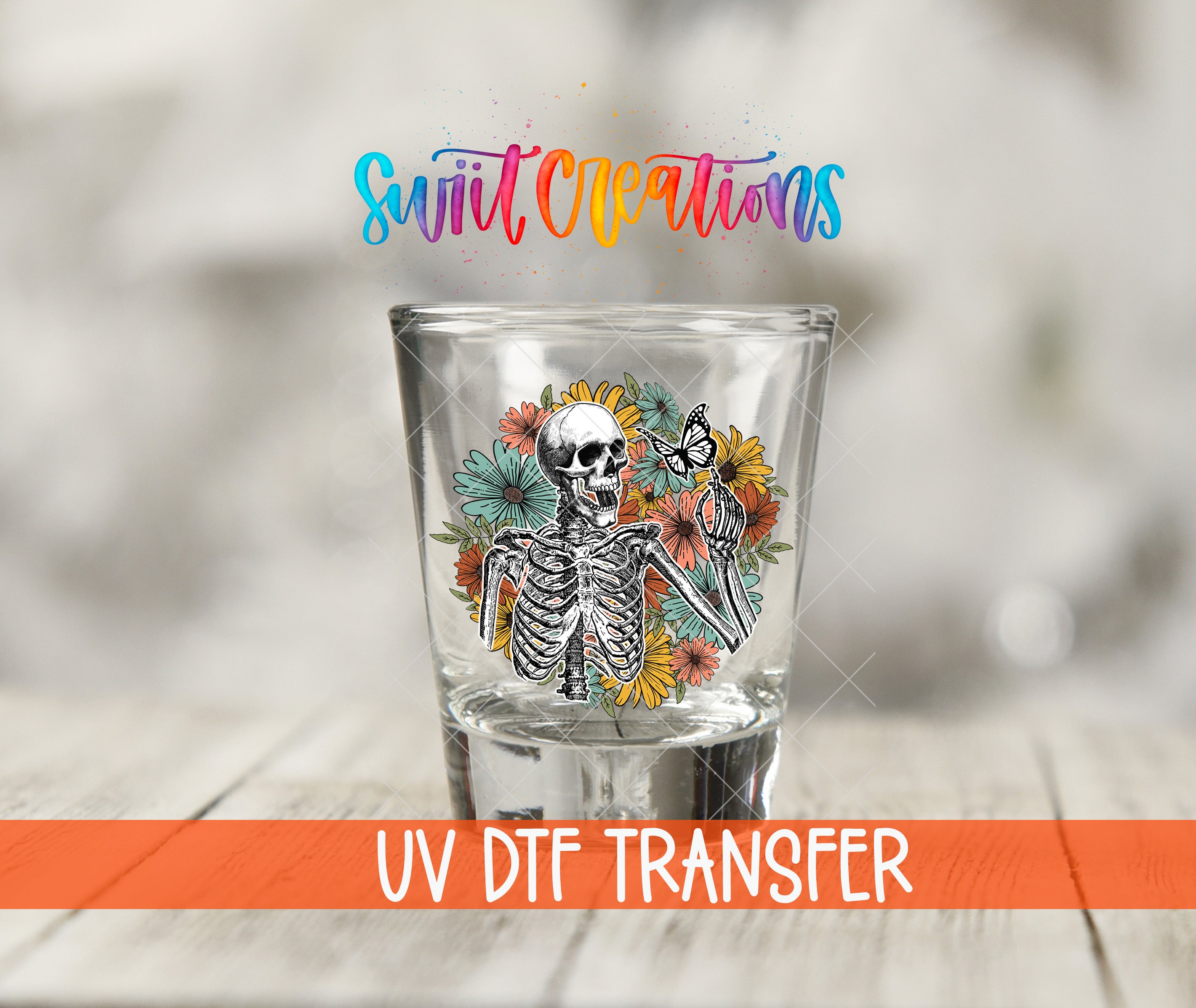 A shot glass with a skeleton design and colorful flowers, along with the text "Swift Creations UV Dtf Transfer".