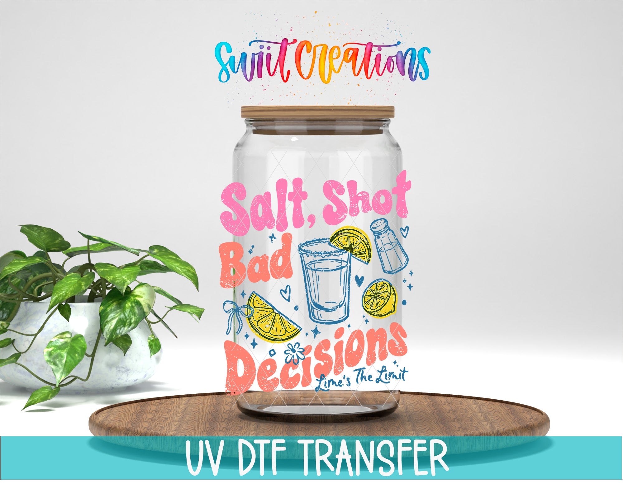 a glass jar with a colorful design and text, placed on a wooden surface next to a potted plant.