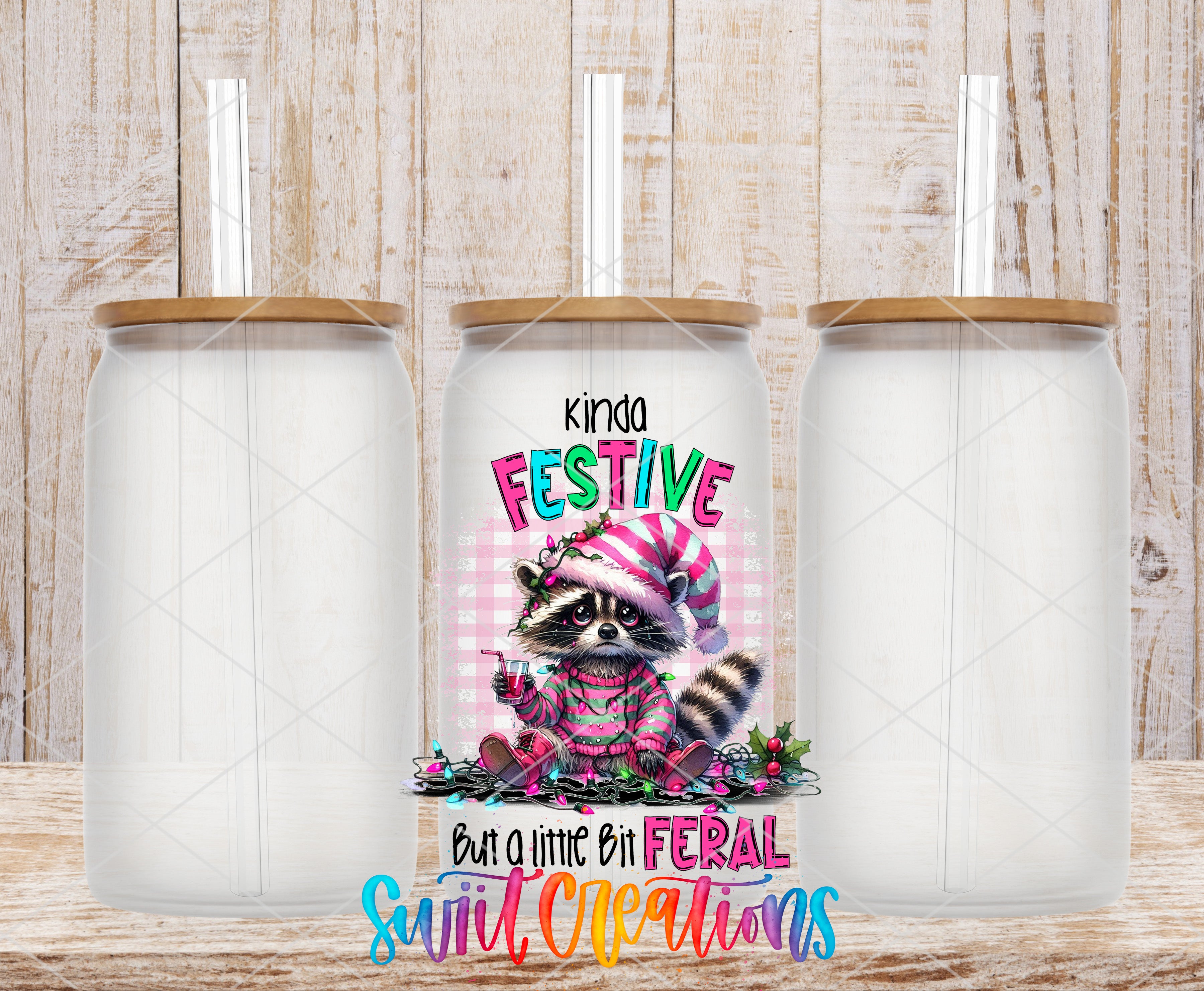 Swiit Creations UV DTF Kinda Festive But a Little Bit Feral transfer shown on a clear glass can set