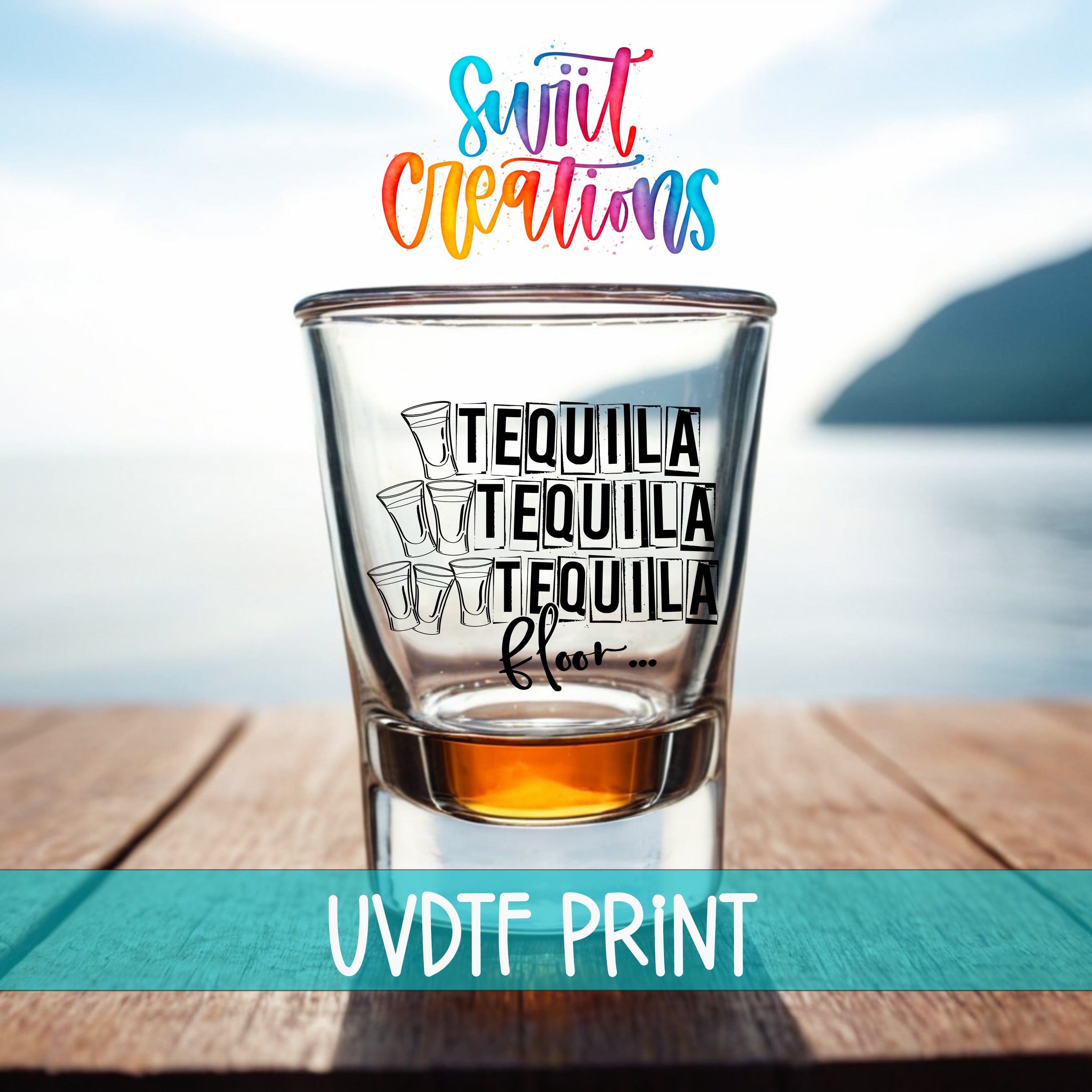 A shot glass with the text "TEQUILA TEQUILA TEQUILA FLOY..." printed on it, placed on a wooden surface with a body of water in the background.