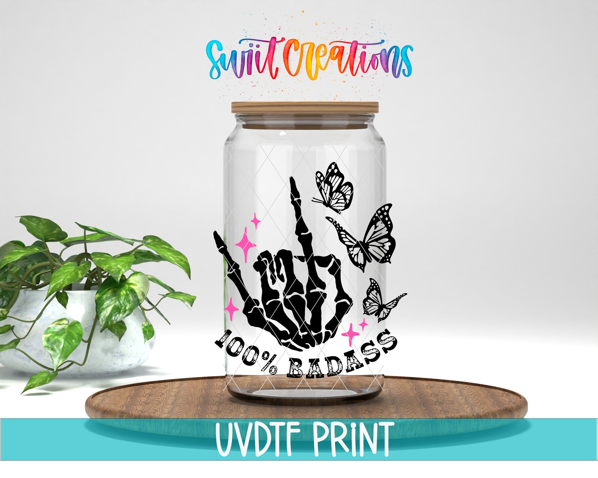 A glass jar with a skeleton hand and butterflies, along with the text "100% BADASS" and "Swift Creations" written above it. The jar is placed on a wooden surface, and there is a potted plant in the background.