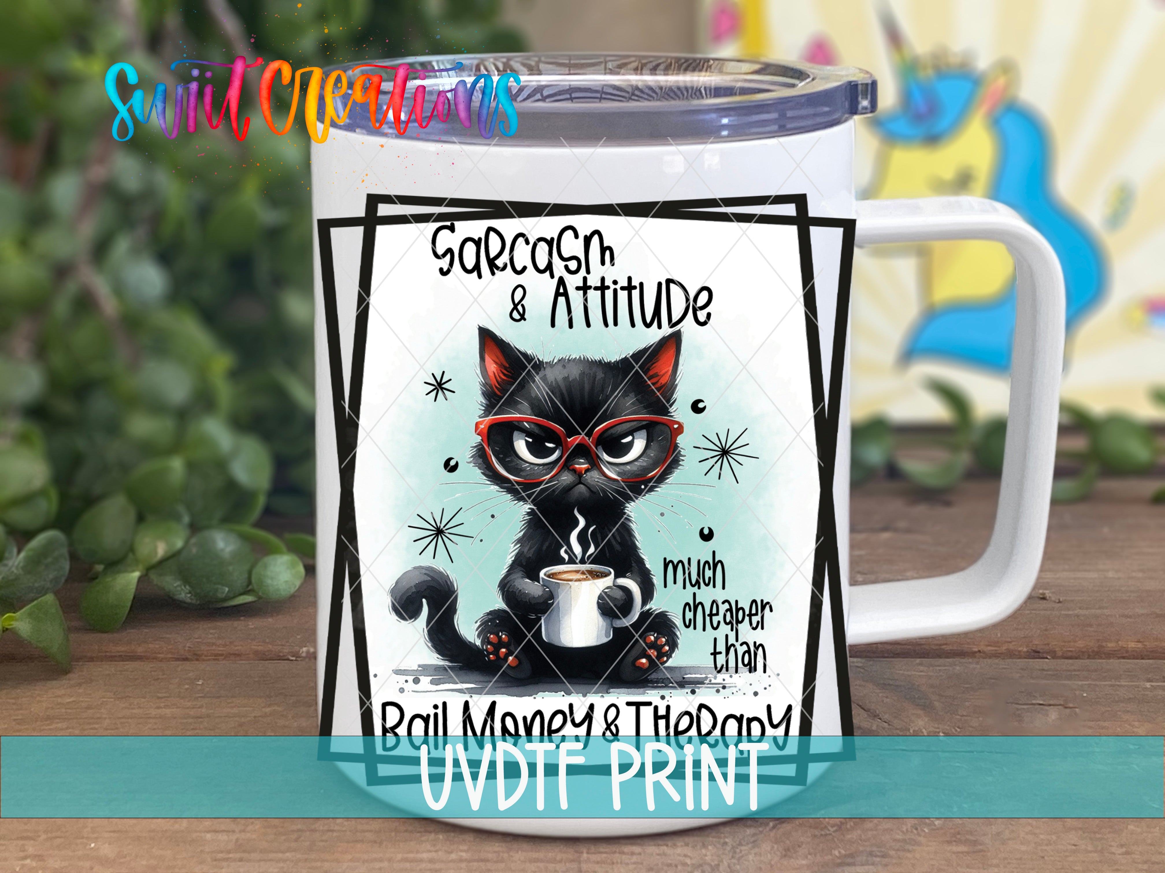 A white mug with a black cat illustration and text on it, placed on a wooden surface.