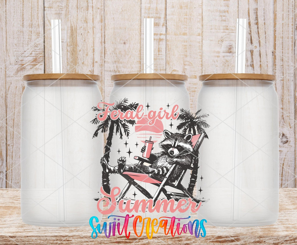 Swiit Creations UV DTF Feral Girl Summer Raccoon transfer shown on a clear glass can set