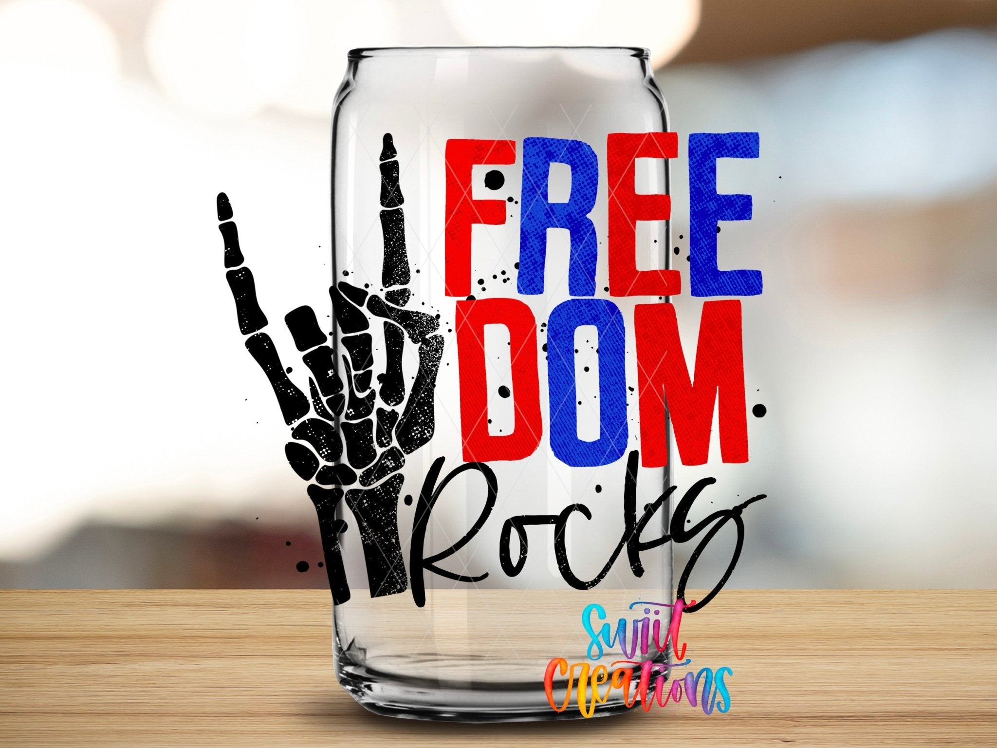 Swiit Creations Freedom Rocks red white and blue skeleton hand UV DTF transfer shown on a clear glass can