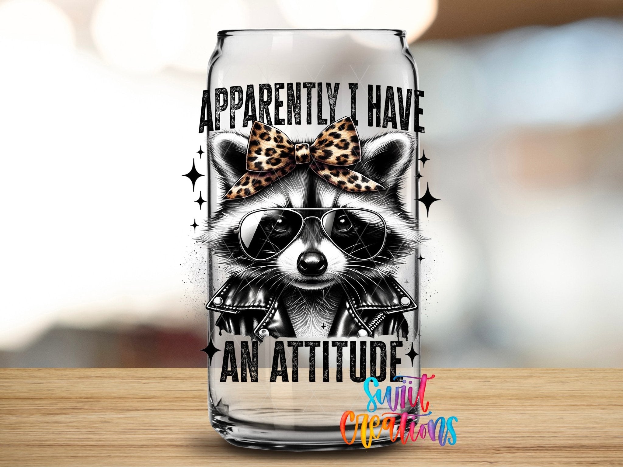 Funny Raccoon Apparently I Have An Attitude UV DTF transfer applied to a clear glass can from Swiit Creations