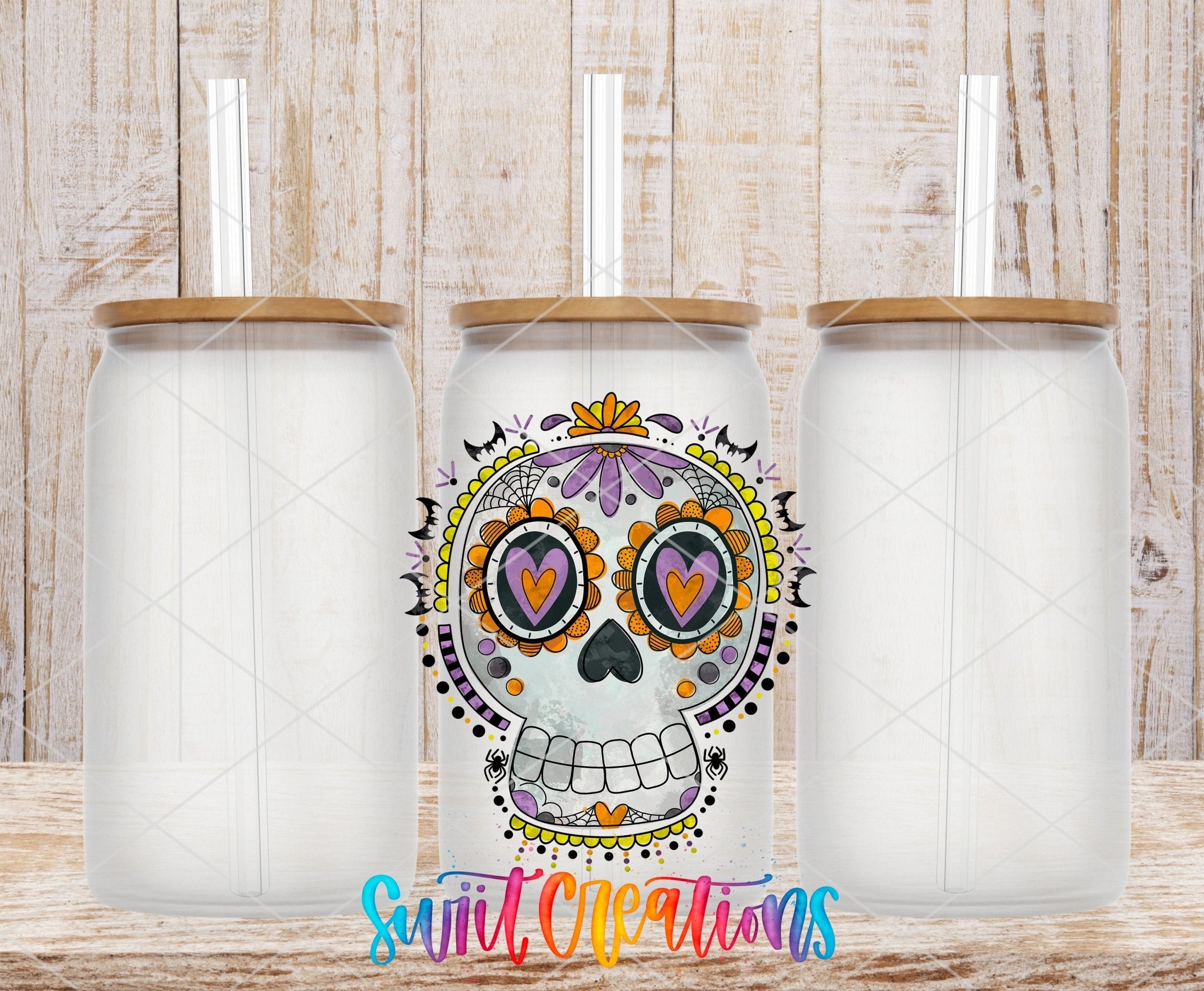 Halloween Sugar Skull Spooky Floral UV DTF transfer applied to a clear glass can set from Swiit Creations