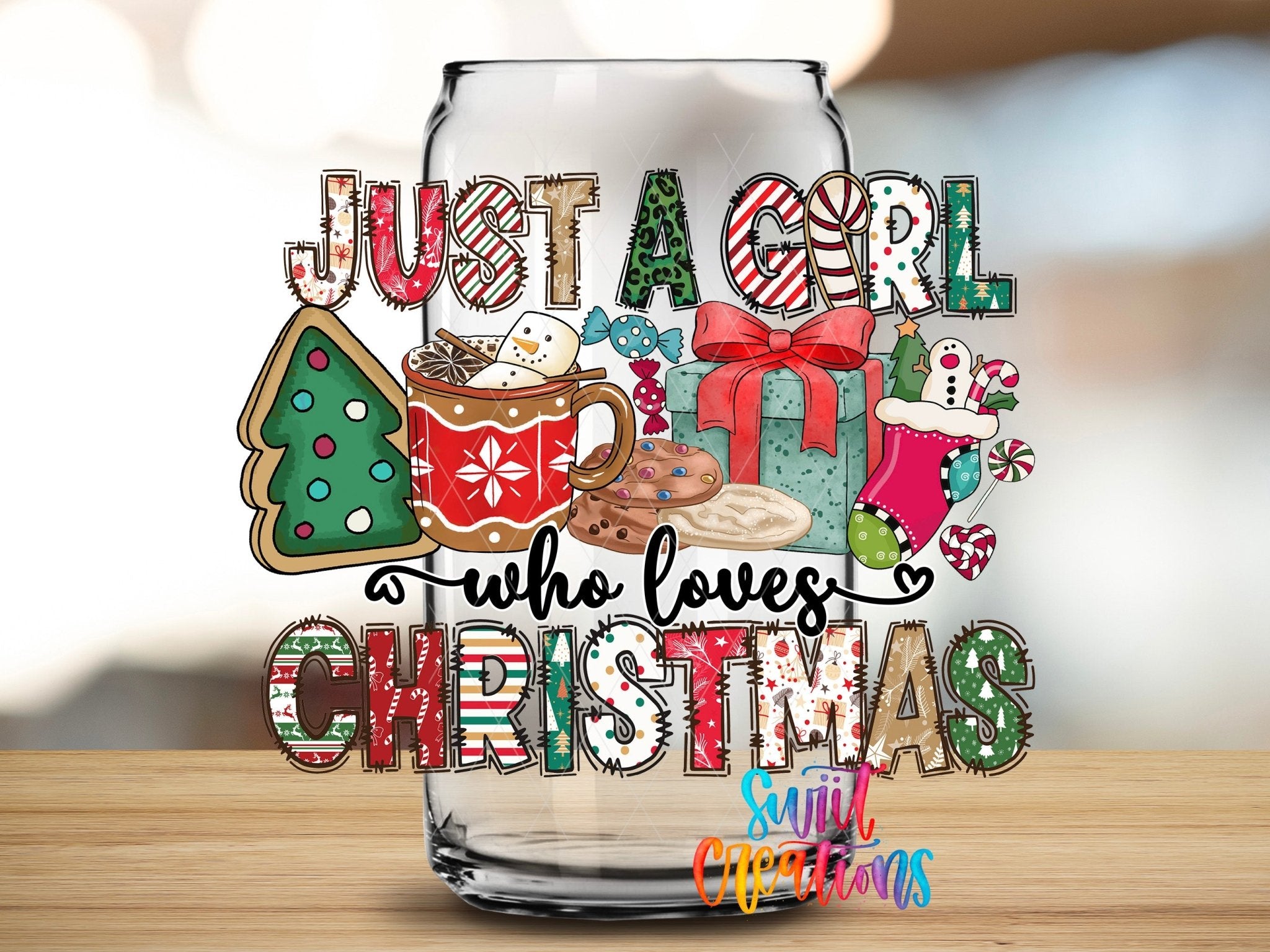 Just a Girl Who Loves Christmas UV DTF transfer applied to a clear glass can from Swiit Creations