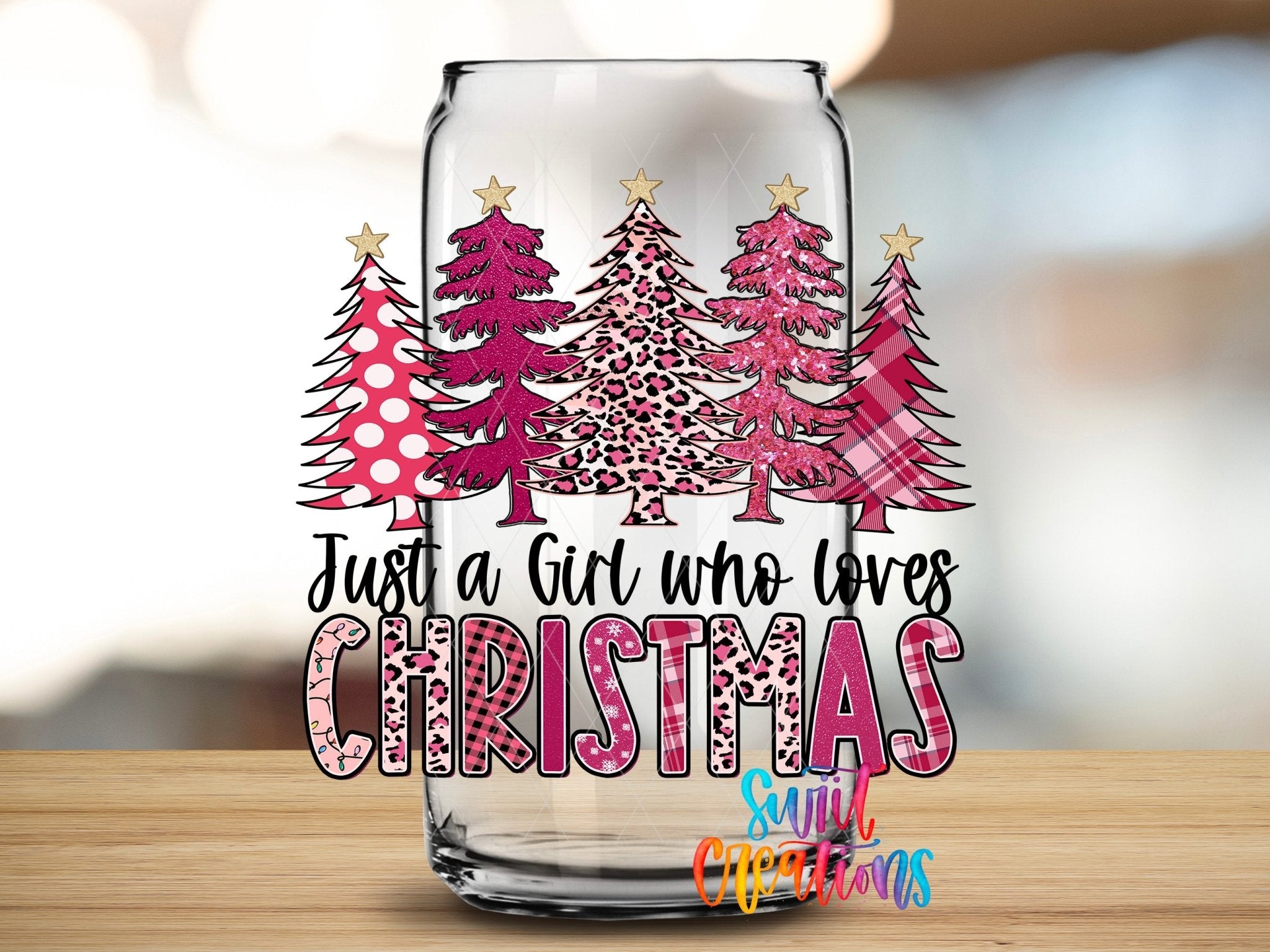 Just a Girl Who Loves Christmas UV DTF transfer applied to a clear glass can from Swiit Creations