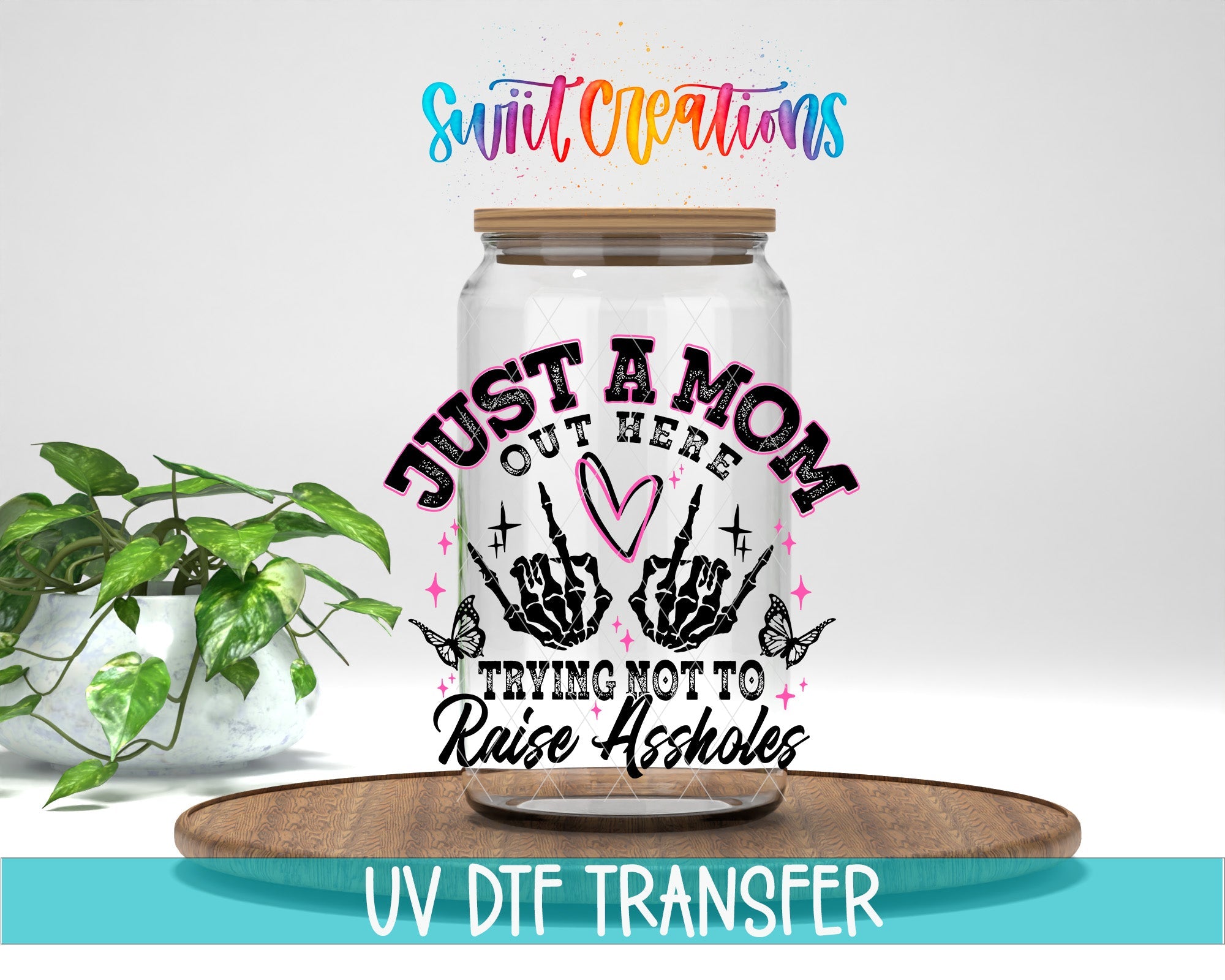 Just a Mom Trying Not To Raise Assholes UV DTF transfer displayed on a clear jar mockup from Swiit Creations
