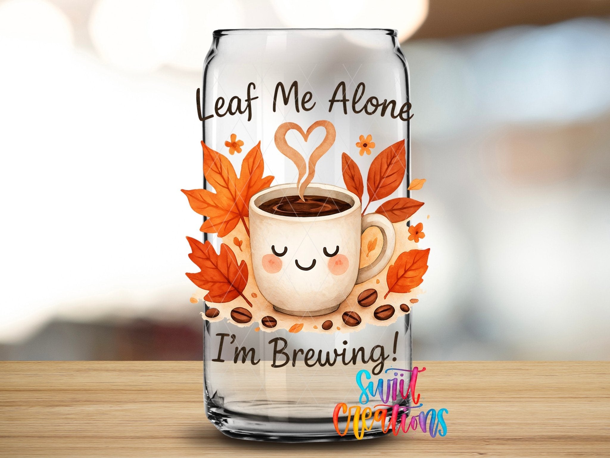 Leaf Me Alone Fall Coffee UV DTF transfer applied to a clear glass can from Swiit Creations