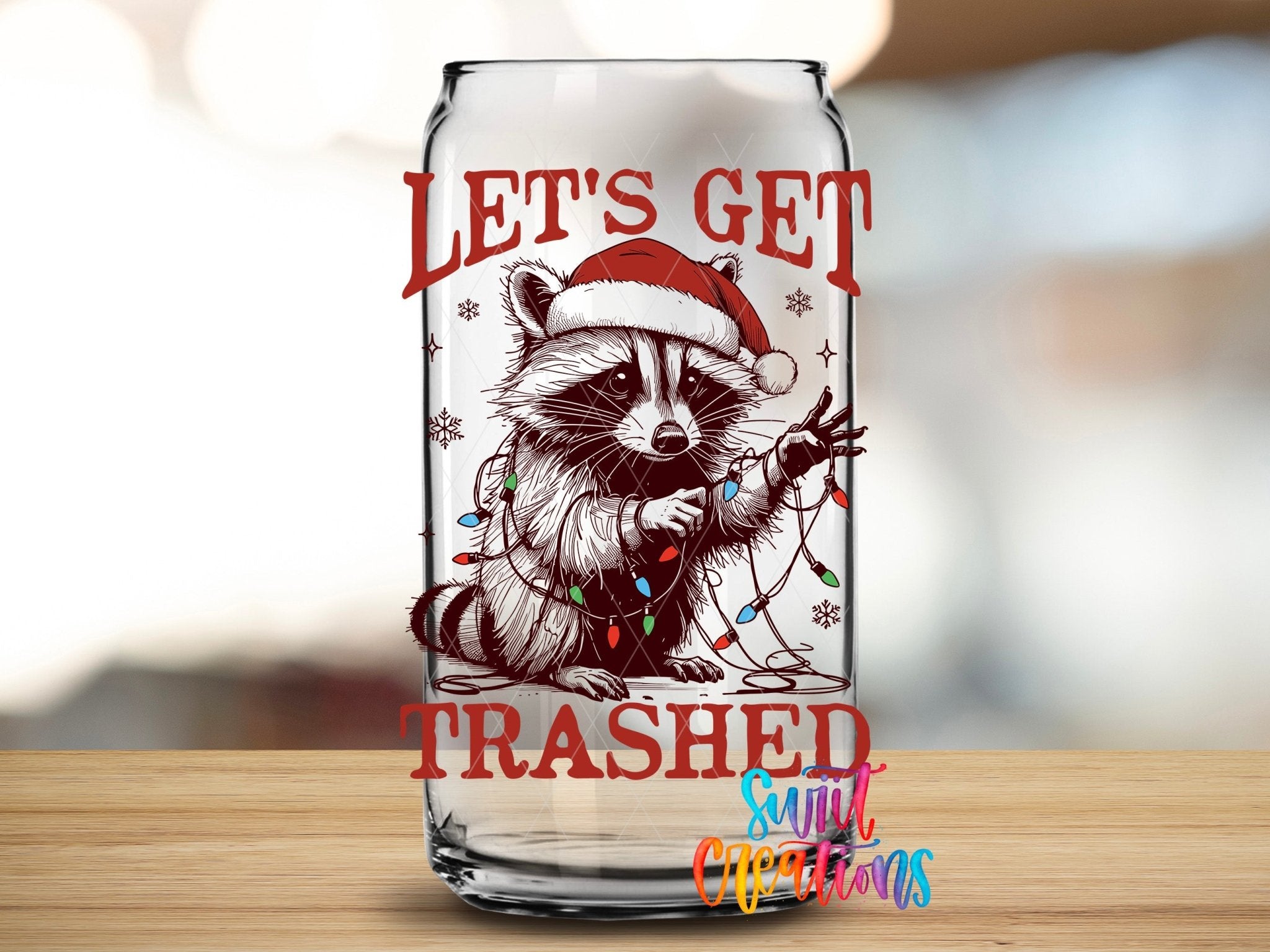 Swiit Creations UV DTF Let’s Get Trashed Christmas Raccoon transfer applied to a clear glass can