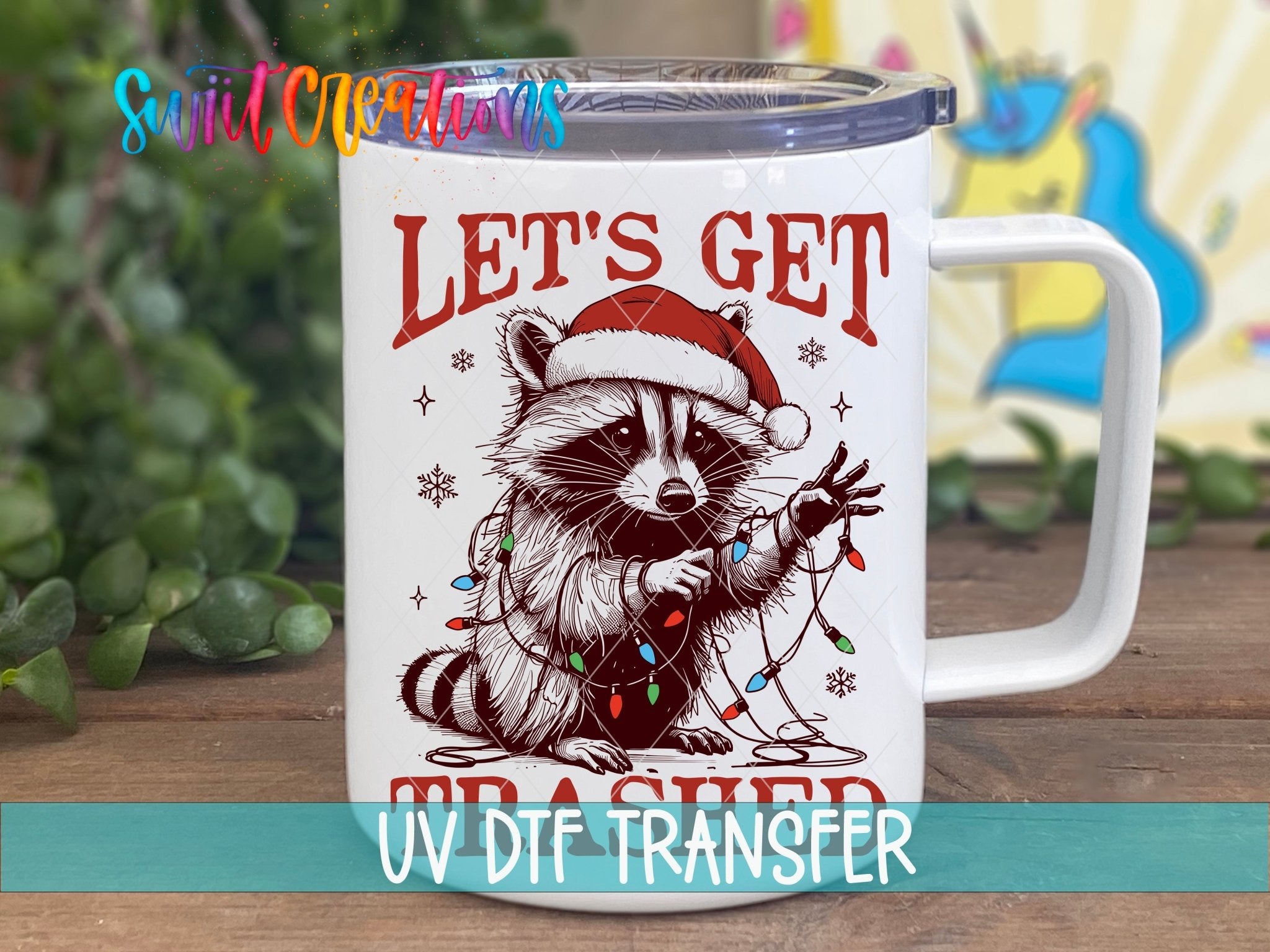 Swiit Creations UV DTF Let’s Get Trashed Christmas Raccoon transfer displayed on a white coffee mug
