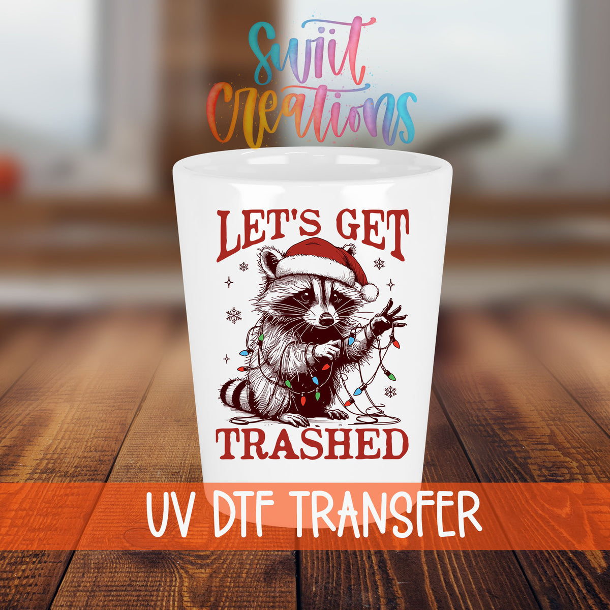 Let's Get Trashed Christmas shot glass transfer on a white shot glass on a wooden table