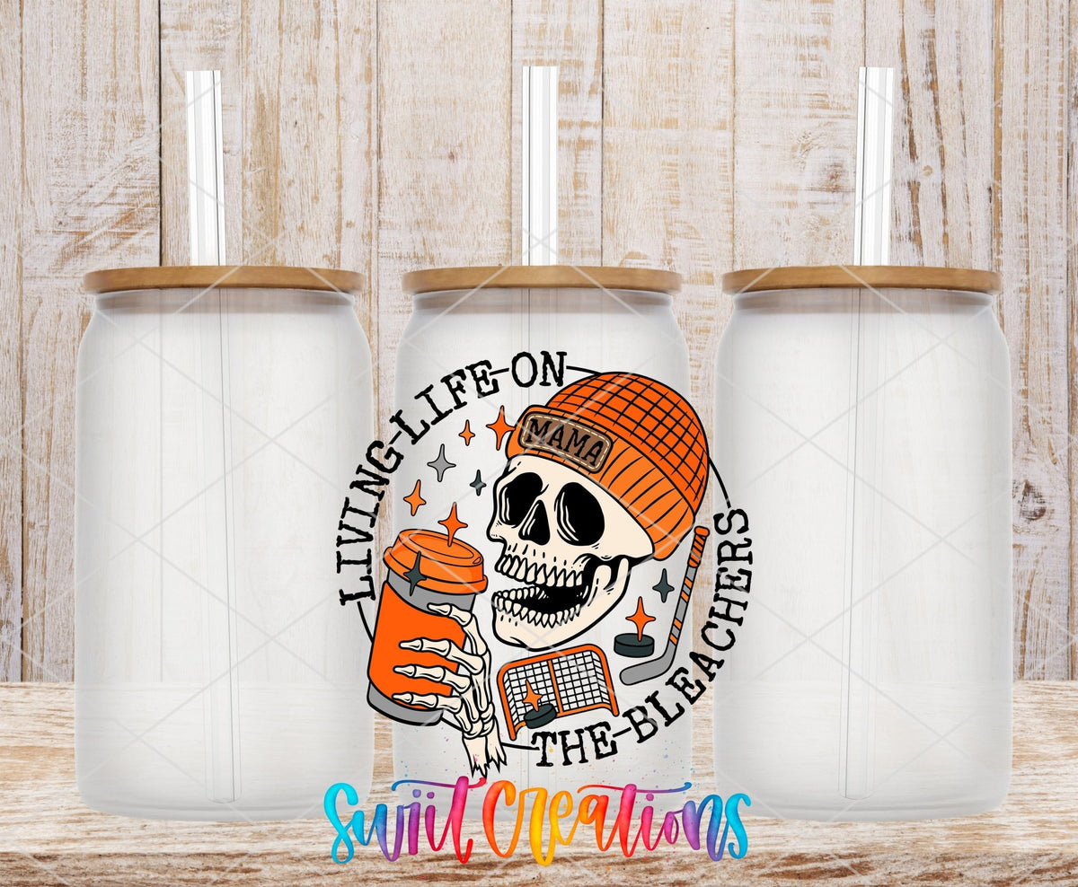 Living Life on the Bleachers skeleton in an orange mama cap UV DTF transfer on frosted glass cans with bamboo lids