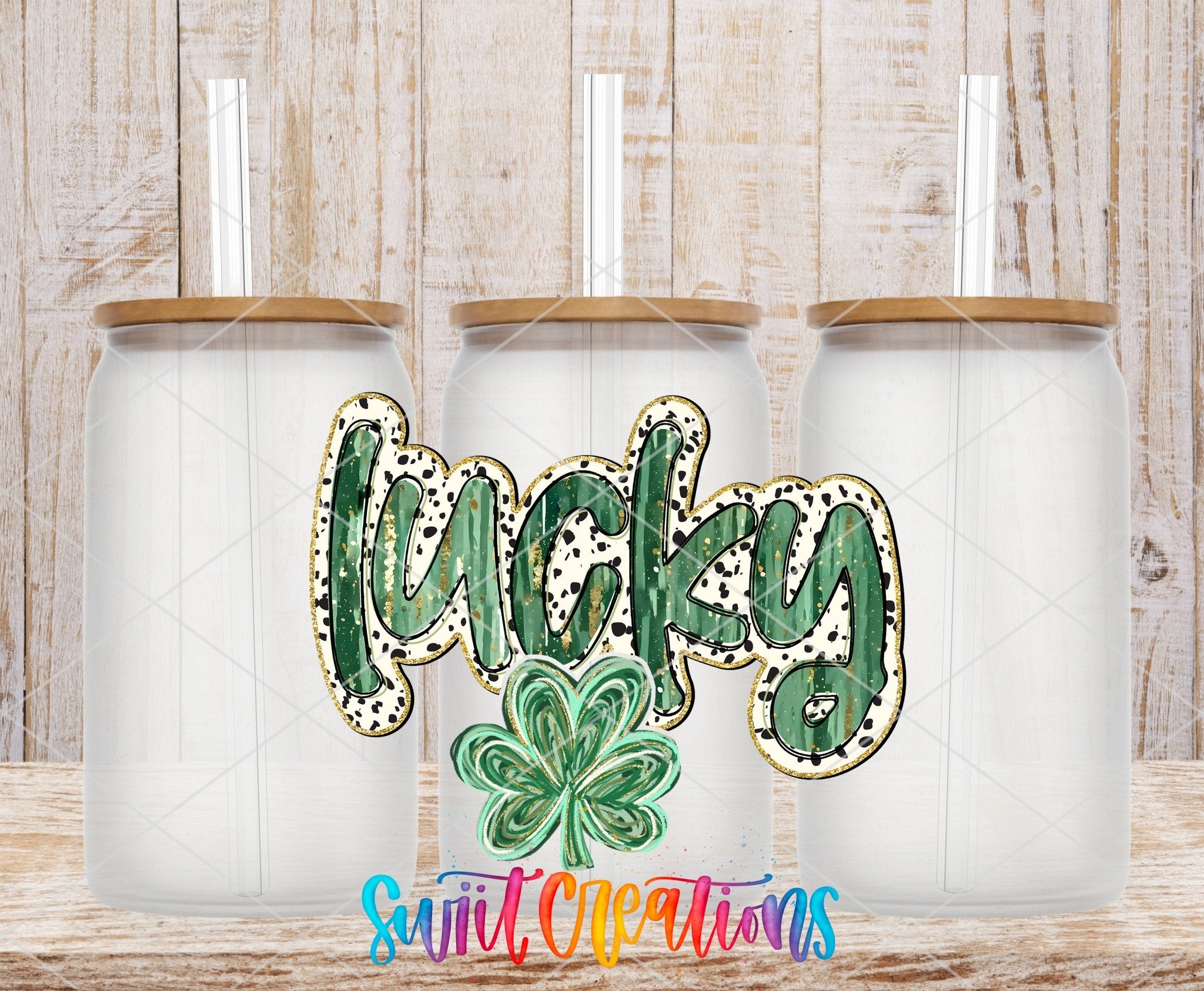 Swiit Creations UV DTF Lucky transfer shown on a clear glass can set