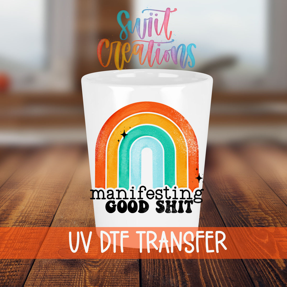 Manifesting Good Sh*t shot glass transfer on a white shot glass on a wooden table