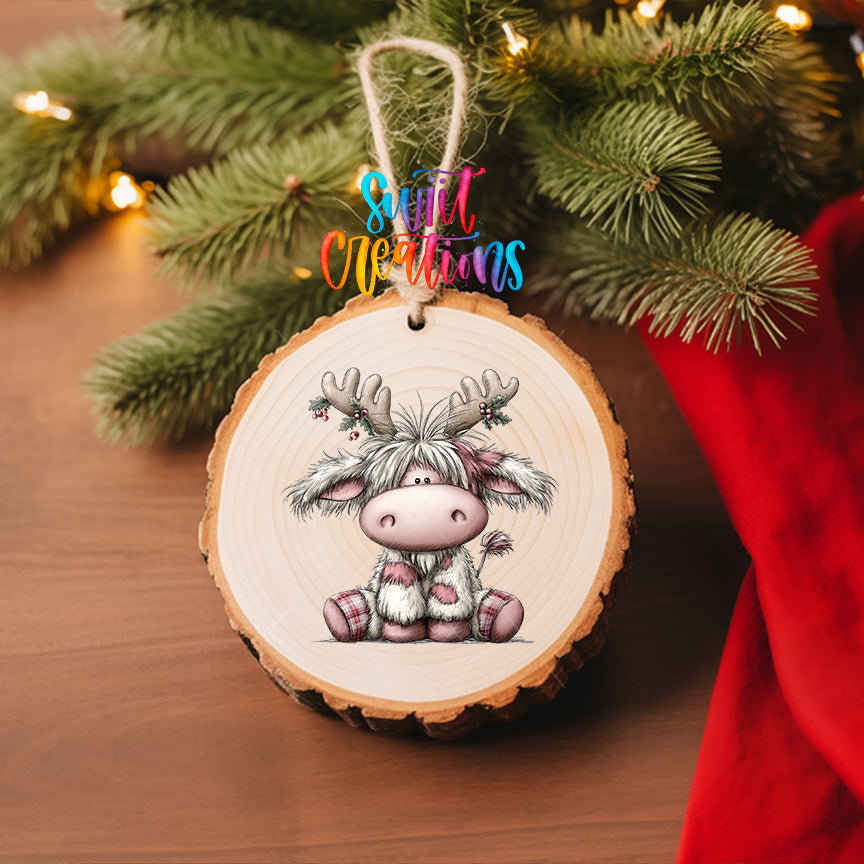 Christmas Highland cow UV DTF transfer displayed on a wood slice ornament