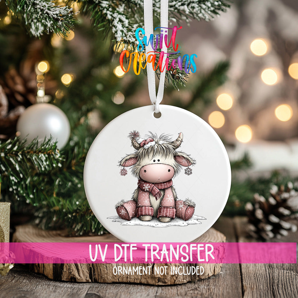 Pink winter Highland cow transfer displayed on a round Christmas ornament mockup