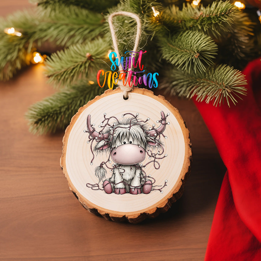 Christmas Highland cow UV DTF transfer shown on a wood slice ornament