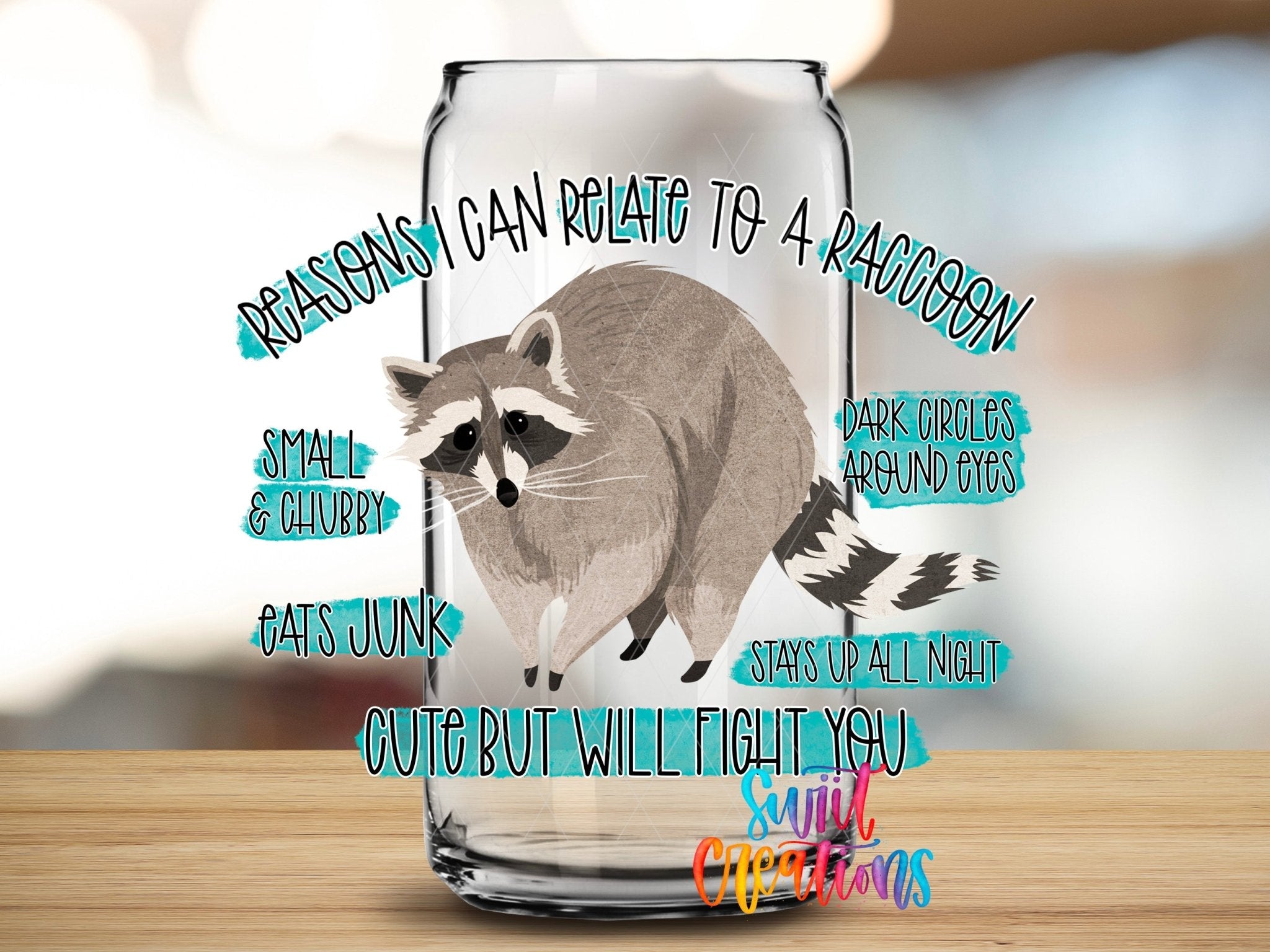 Relate to a Raccoon UV DTF transfer applied to a clear glass can from Swiit Creations