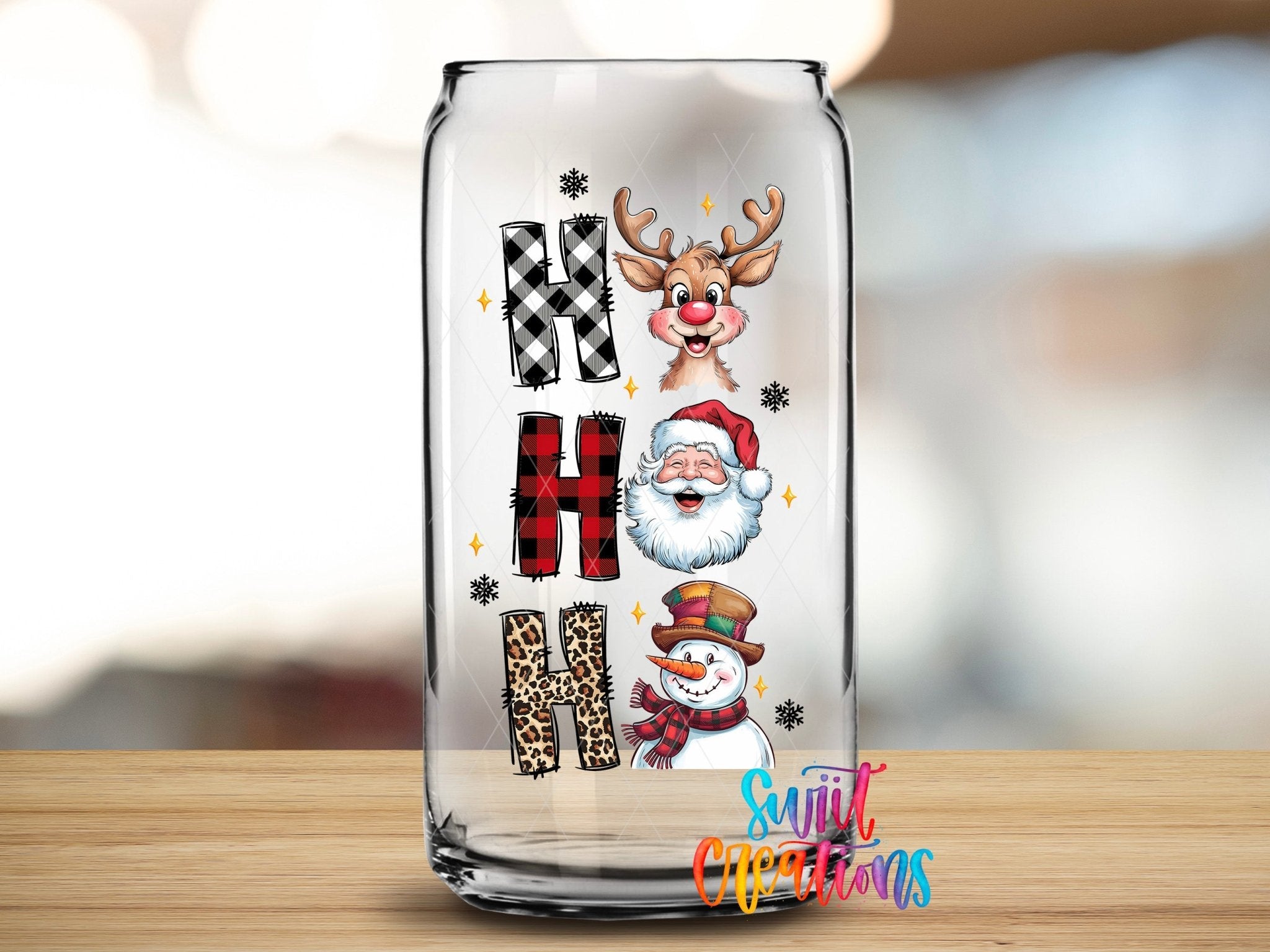 Swiit Creations UV DTF Santa Reindeer Snowman transfer applied to a clear glass can