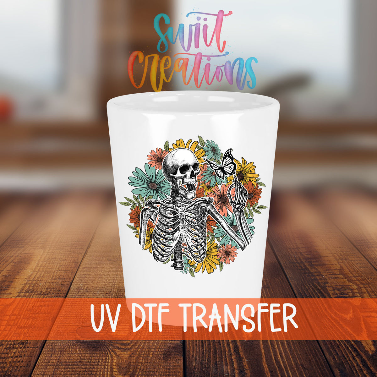 Skeleton Floral shot glass transfer on a white shot glass on a wooden table