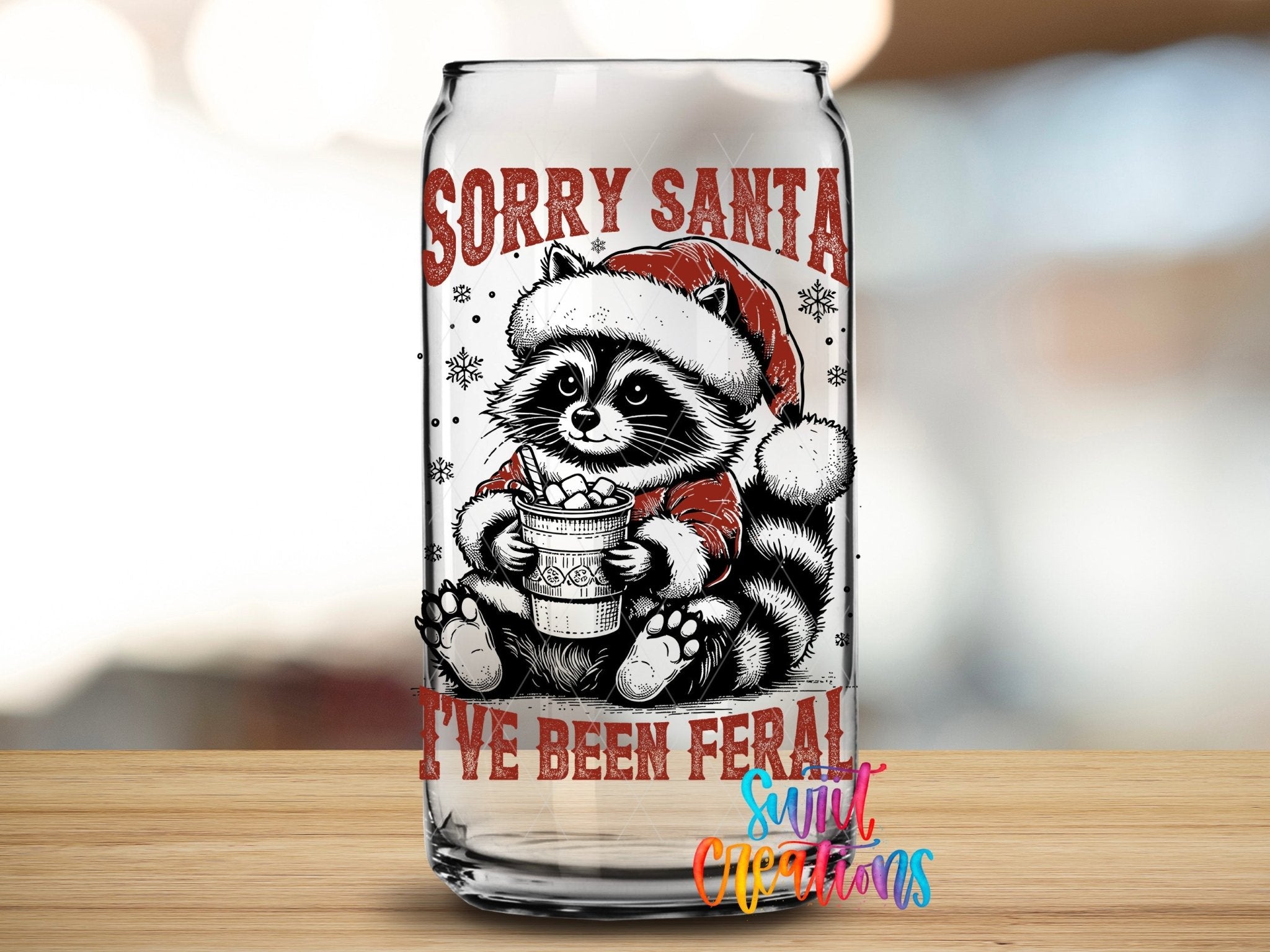 Swiit Creations UV DTF Feral Raccoon Christmas transfer applied to a clear glass can