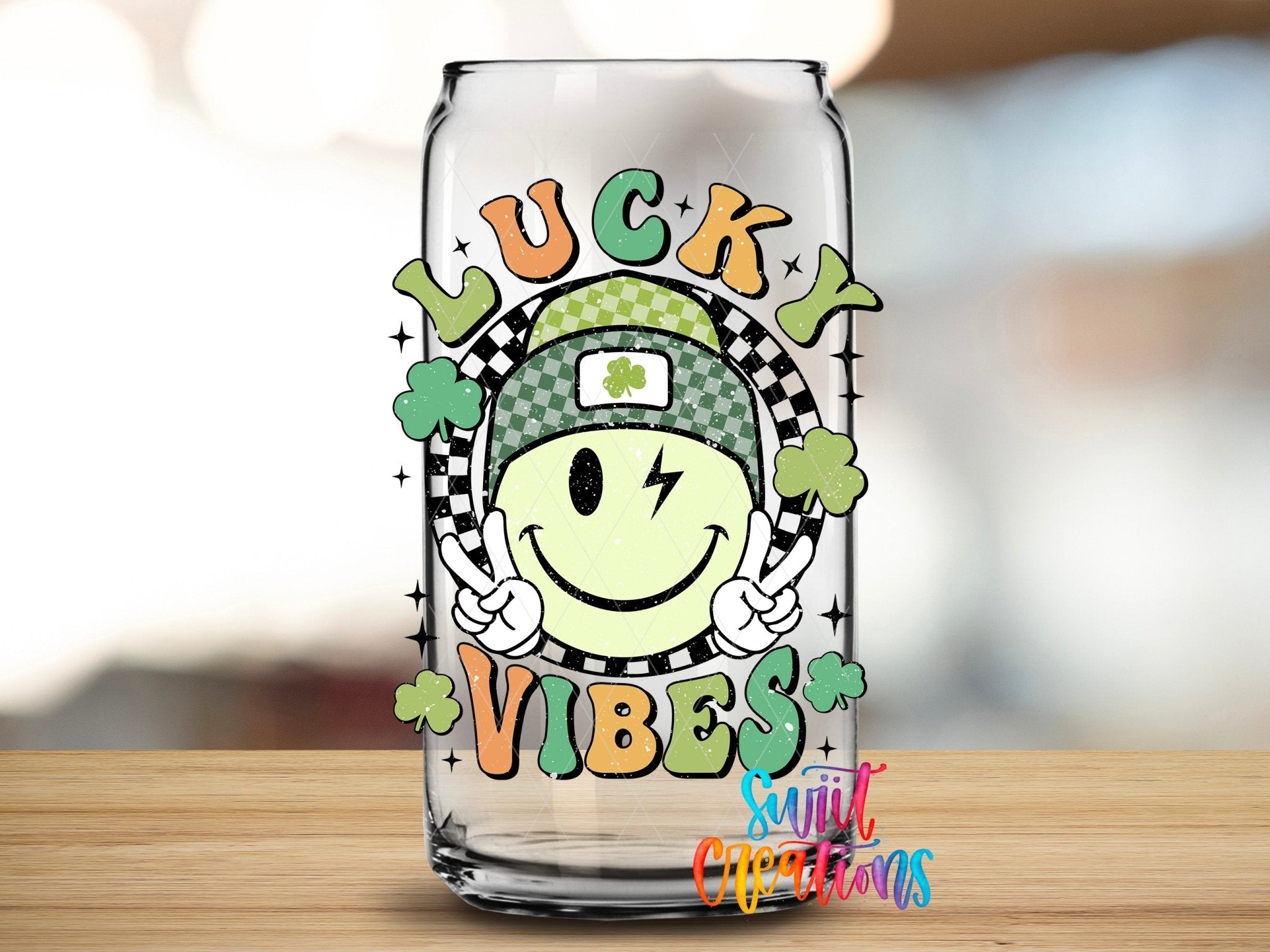 St Patricks Lucky Vibes UV DTF transfer applied to a clear glass can from Swiit Creations