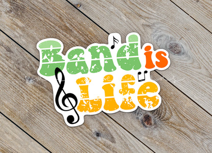 Close-up of the Band Is Life sticker on rustic wood