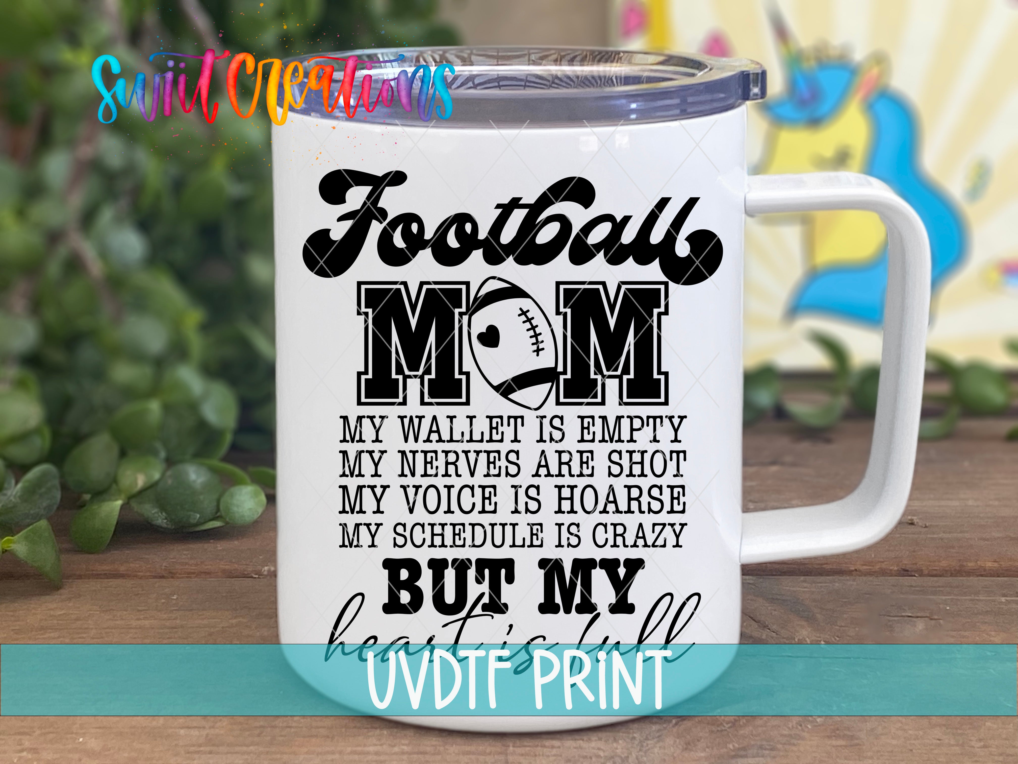 a white coffee mug with the words football mom on it