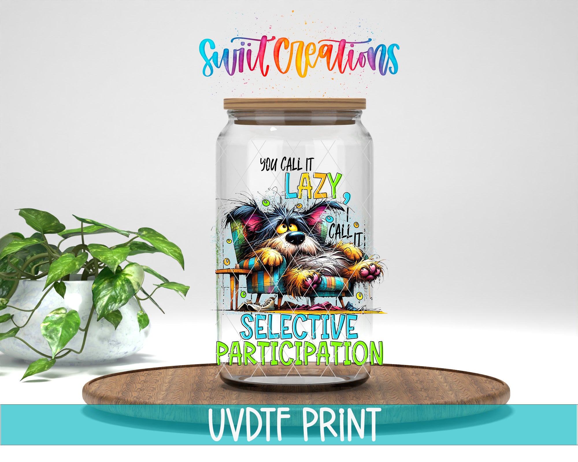 A glass jar with a colorful illustration of a cat sitting on a chair, accompanied by text that reads "You call it lazy, you call it selective participation". The jar is placed on a wooden surface, and there is a potted plant in the background.