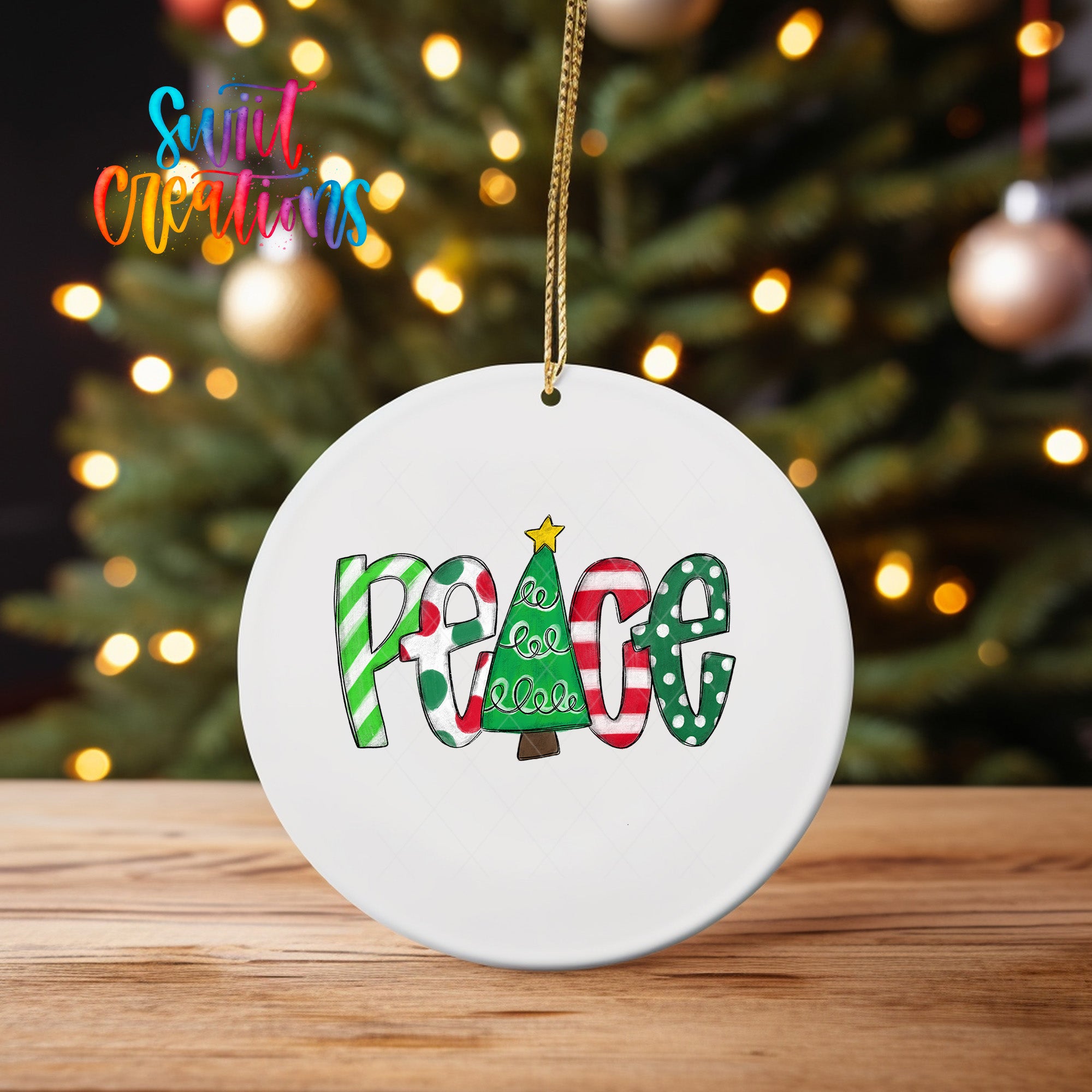 A white ceramic ornament with the word "Peace" written on it, hanging from a string.