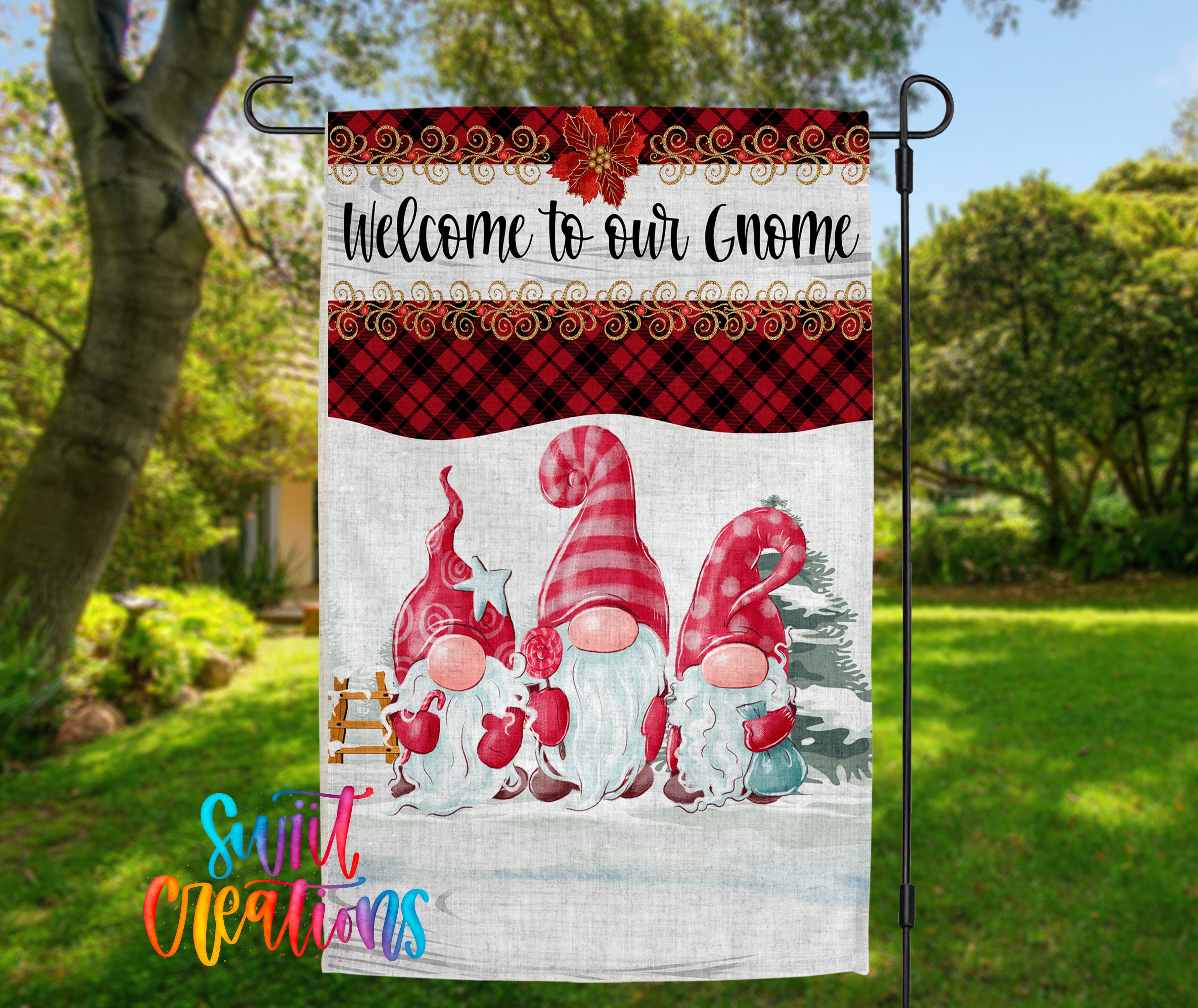 A garden sign featuring three gnomes in a snowy landscape, with a "Welcome to our Gnome" message and a red and black plaid border.