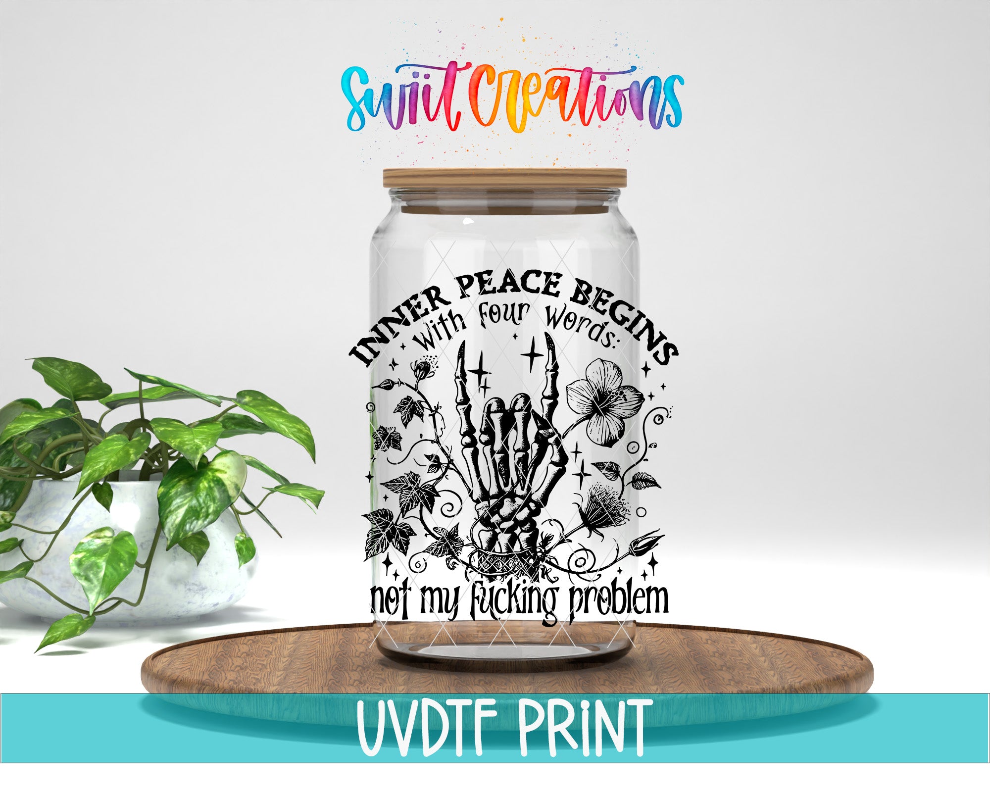 a glass jar with a skeleton hand and floral design, placed on a wooden surface. The jar has a label that says "Inner Peace Begins with Four Words: not my fucking problem".