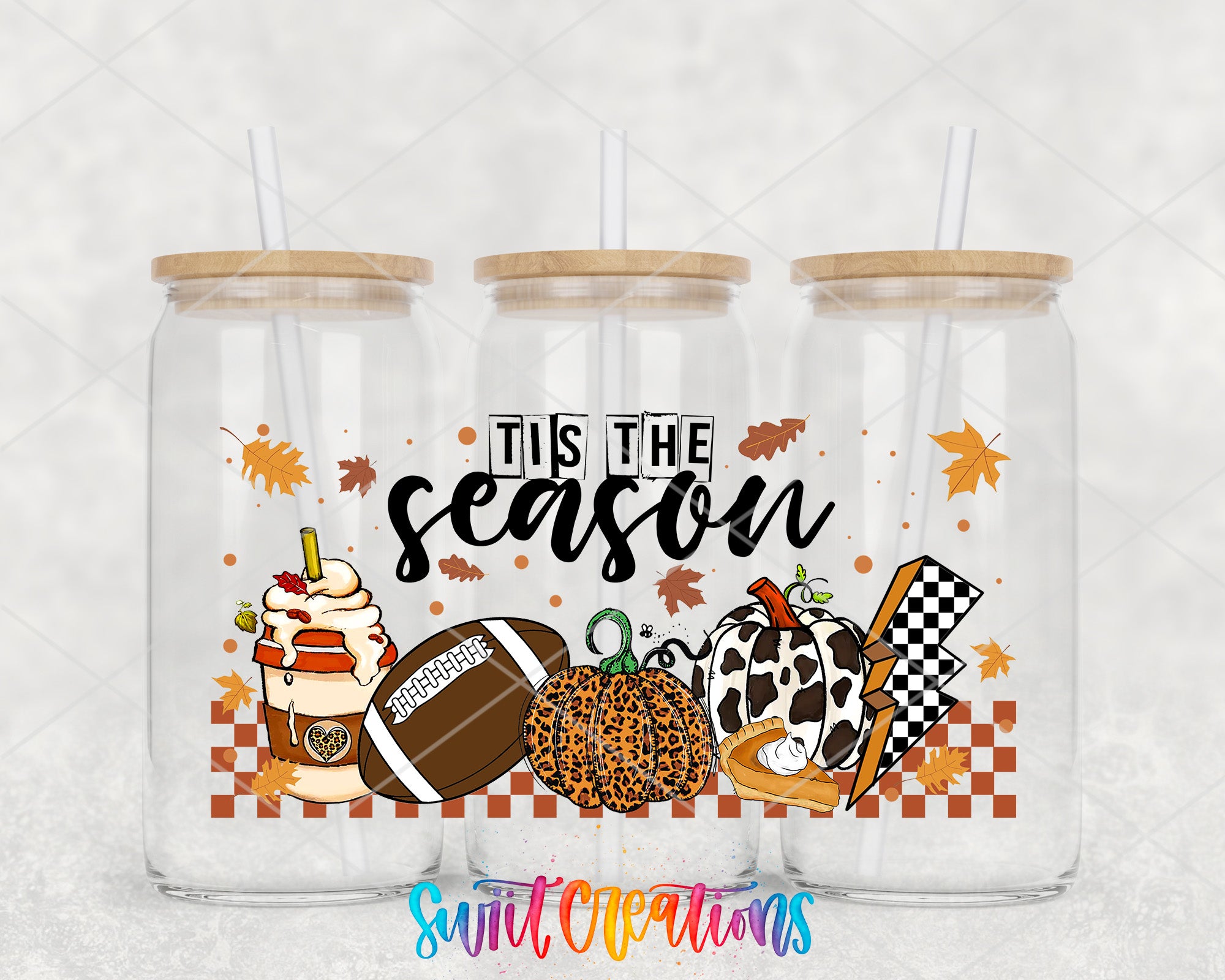 A collection of three glass jars with straws, each containing a different fall-themed item, such as a hot chocolate drink, a pumpkin, a football, and a checkered flag. The jars are set against a white background, and the text "TIS THE SEASON" is prominently displayed in the center.