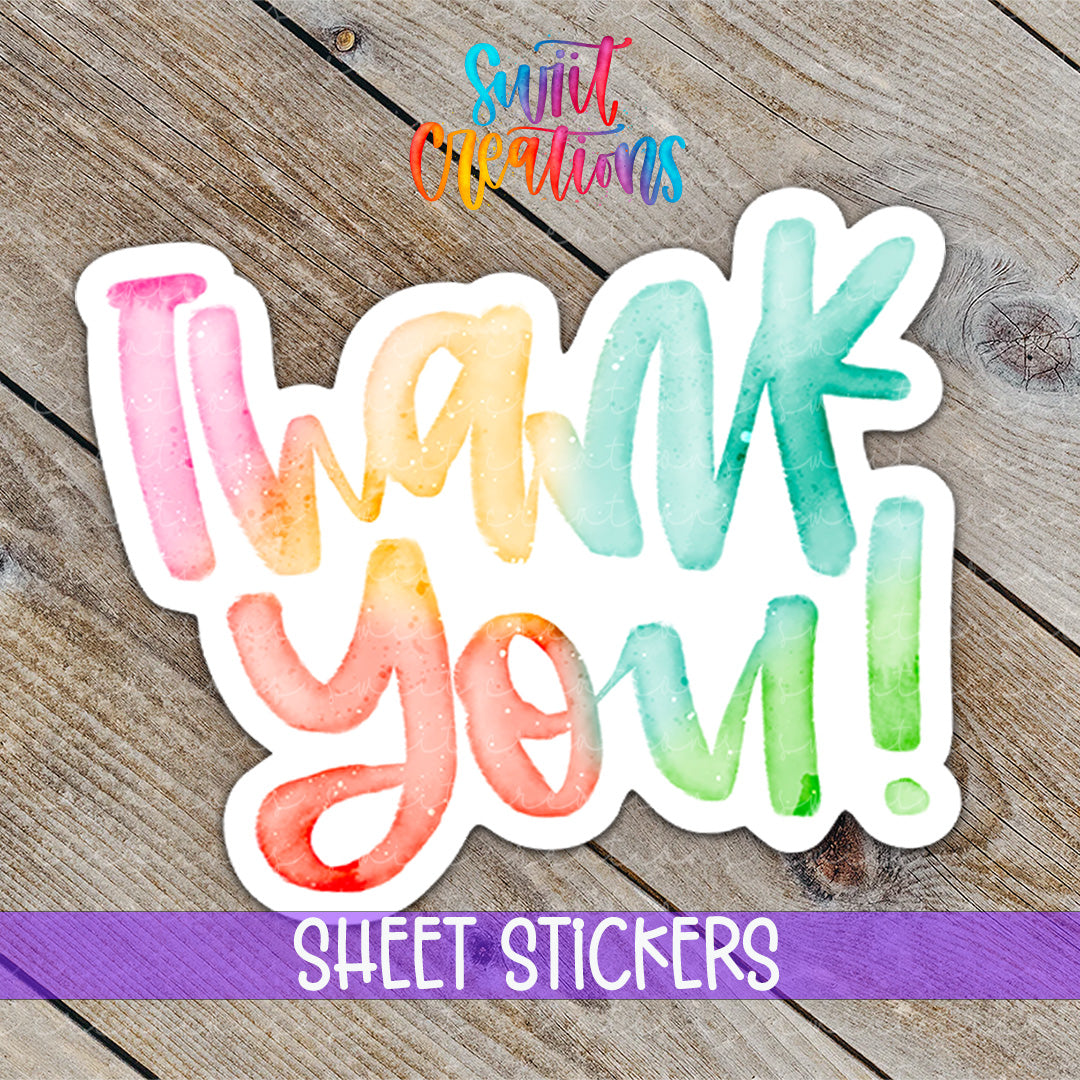 a watercolor thank you sticker on a wooden surface