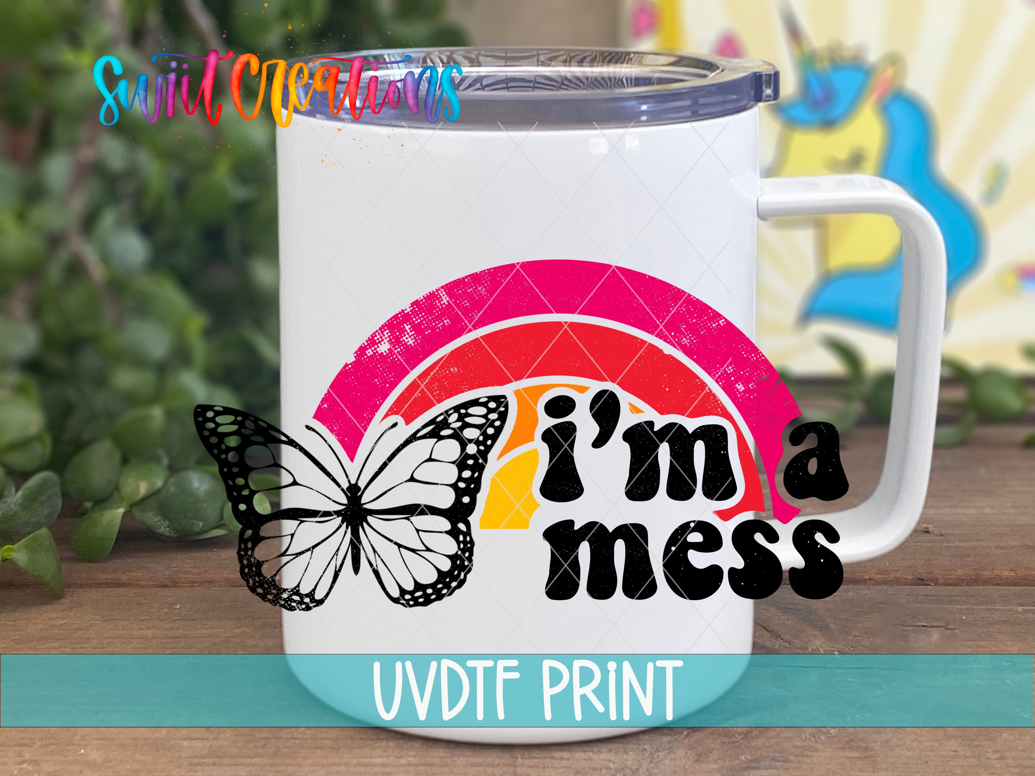 a white coffee mug with a butterfly on it that says i'm a mess