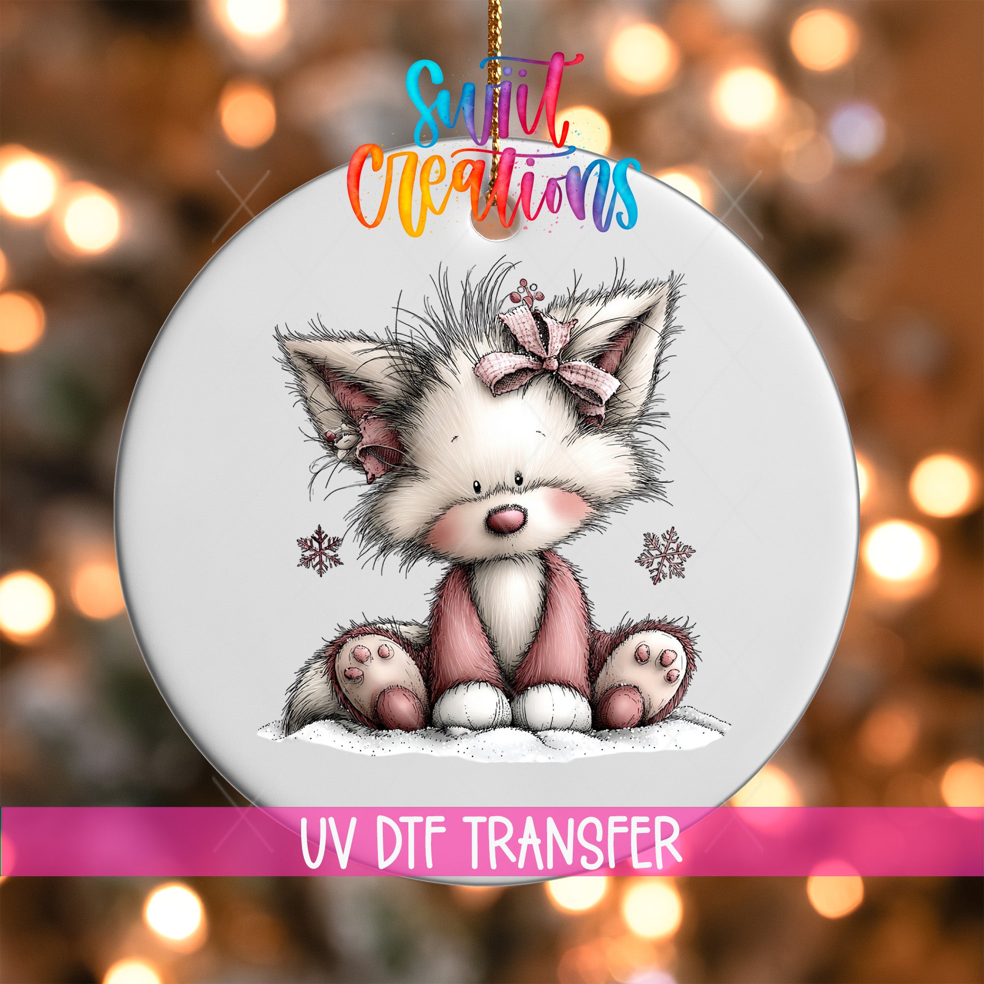 A ceramic ornament featuring a cute, furry cat with a bow on its head, sitting on a snowy surface. The ornament is hanging from a string, and there is a pink ribbon with text that reads "UV Dtf Transfer".