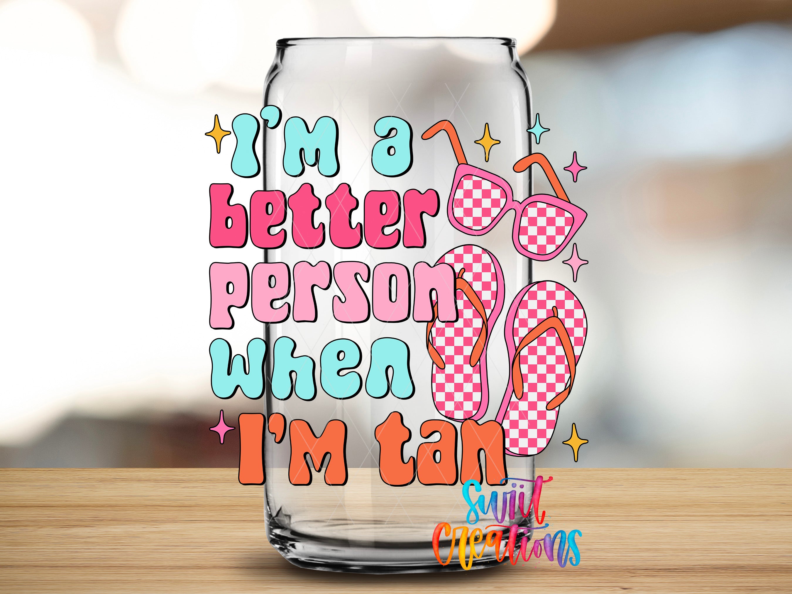 a glass jar with a colorful design and text that reads "I'm a better person when I'm tan".