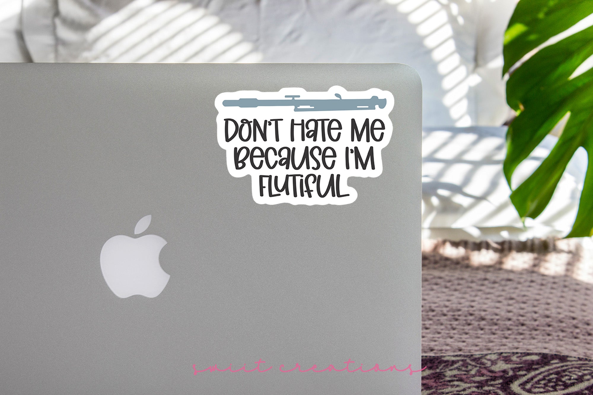 a laptop with a sticker that says don't hate me because i '