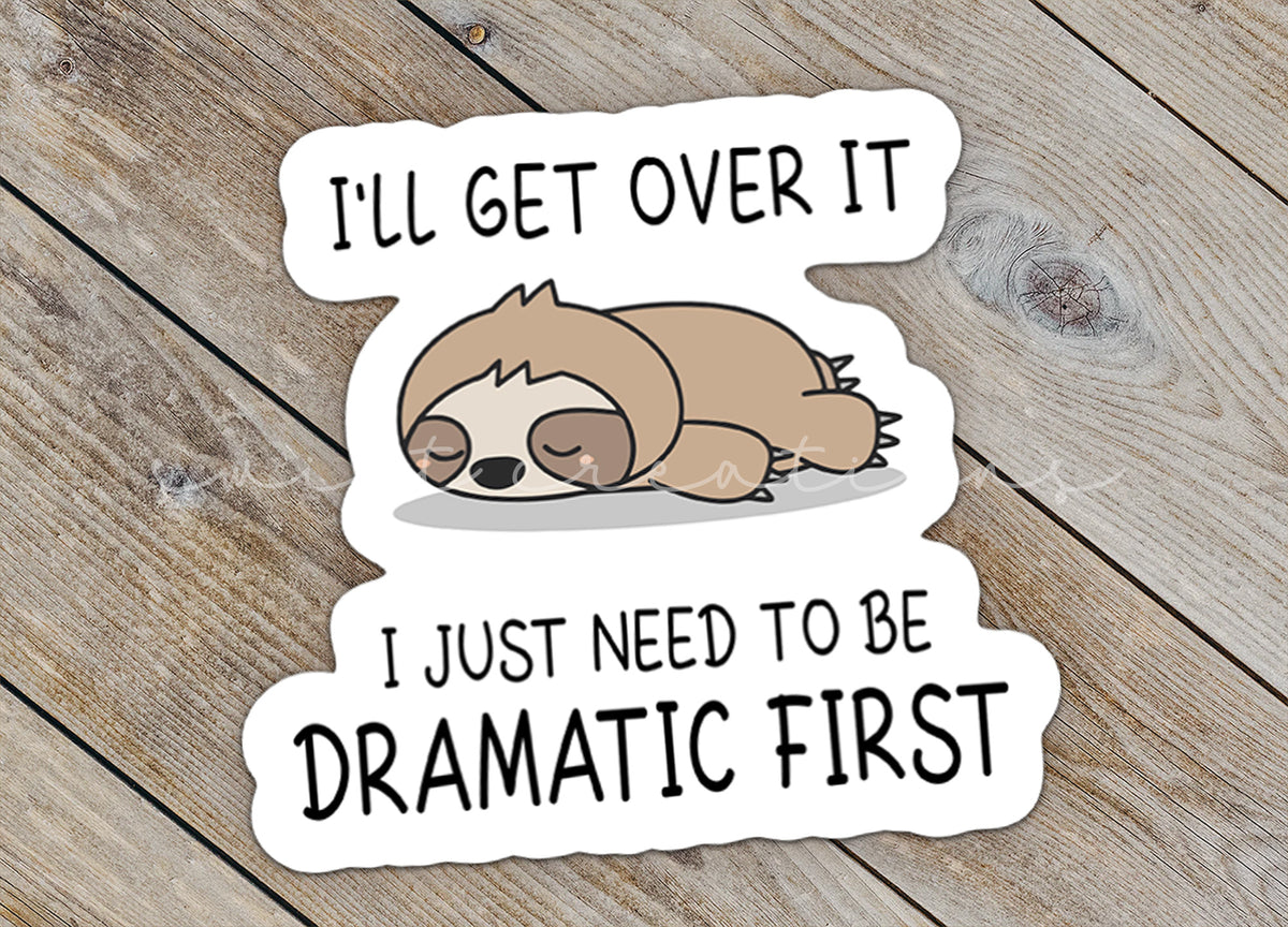 Close-up of the Dramatic Sloth sticker on rustic wood