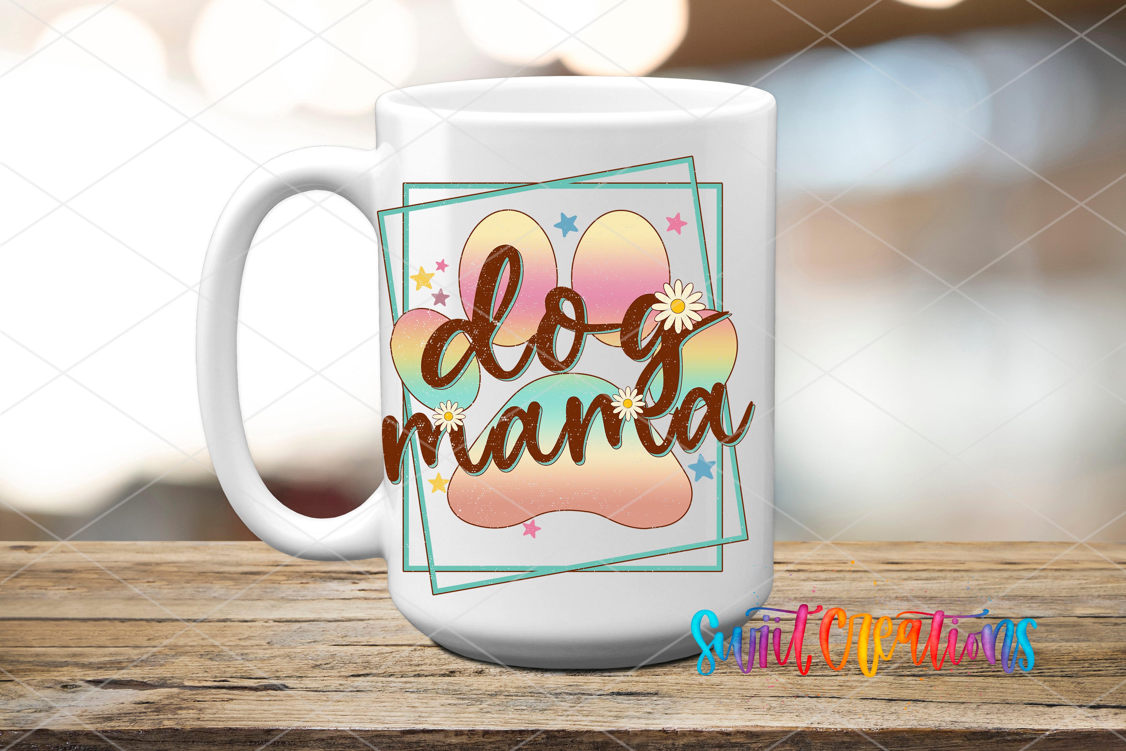 A white ceramic mug with a colorful design featuring a dog paw and the text "dog mama" on it, placed on a wooden surface.