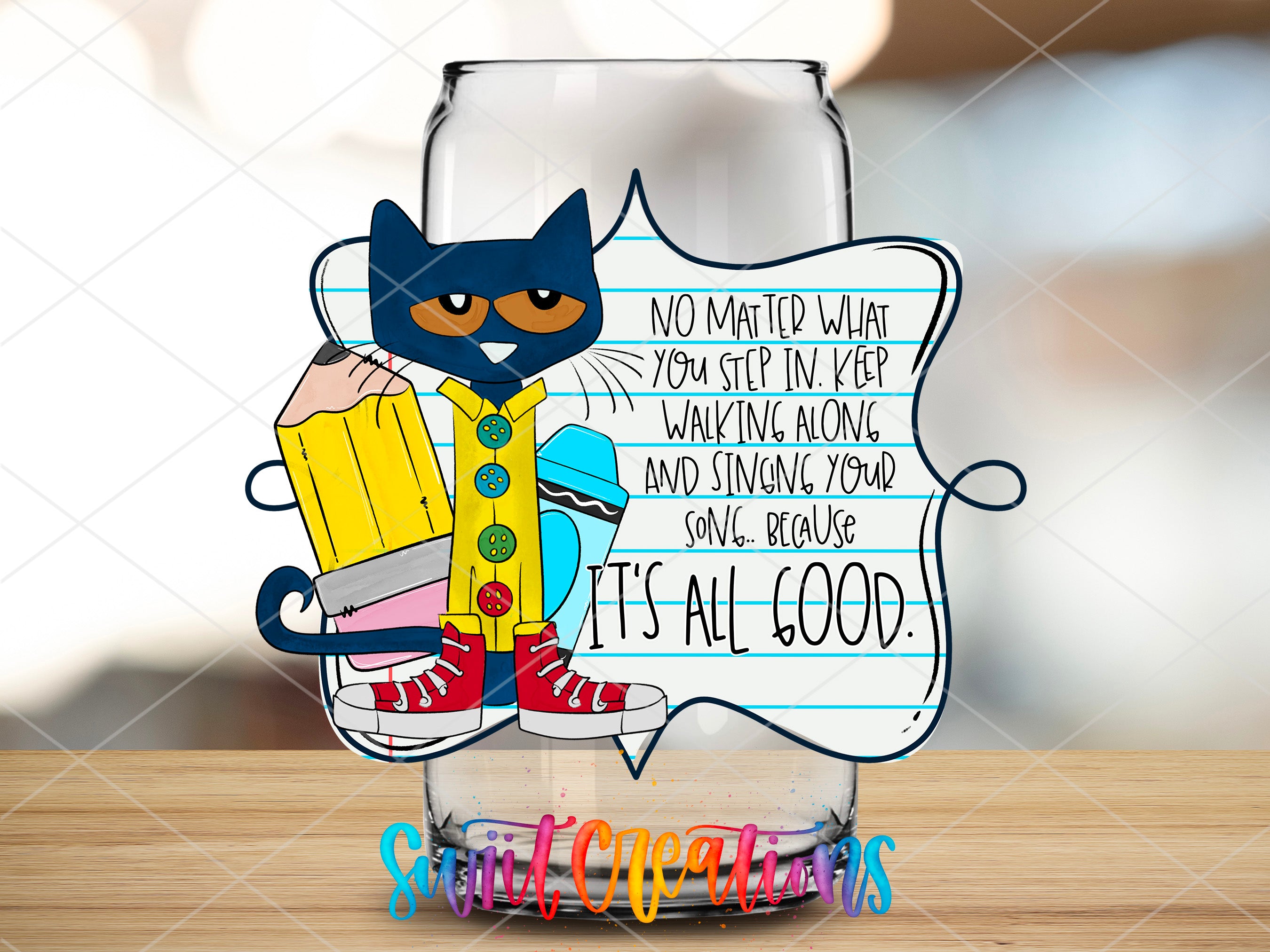 a glass with a picture of a cat holding a pencil
