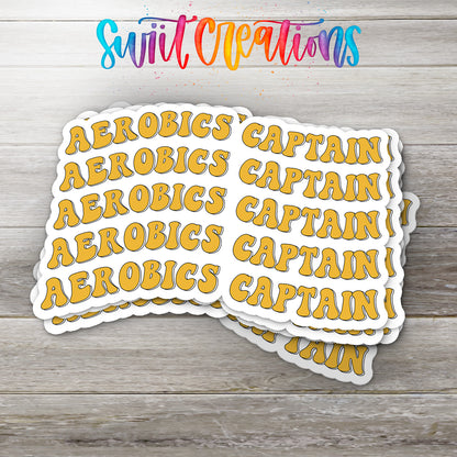 A stack of yellow stickers with the word "CAPTAIN" written on them, placed on a wooden surface.