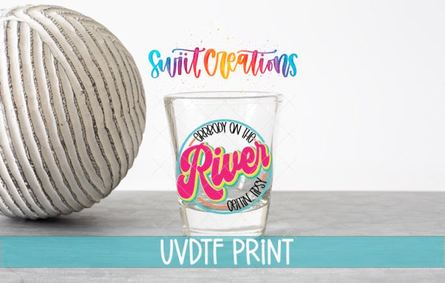 a glass with a ball of yarn next to it