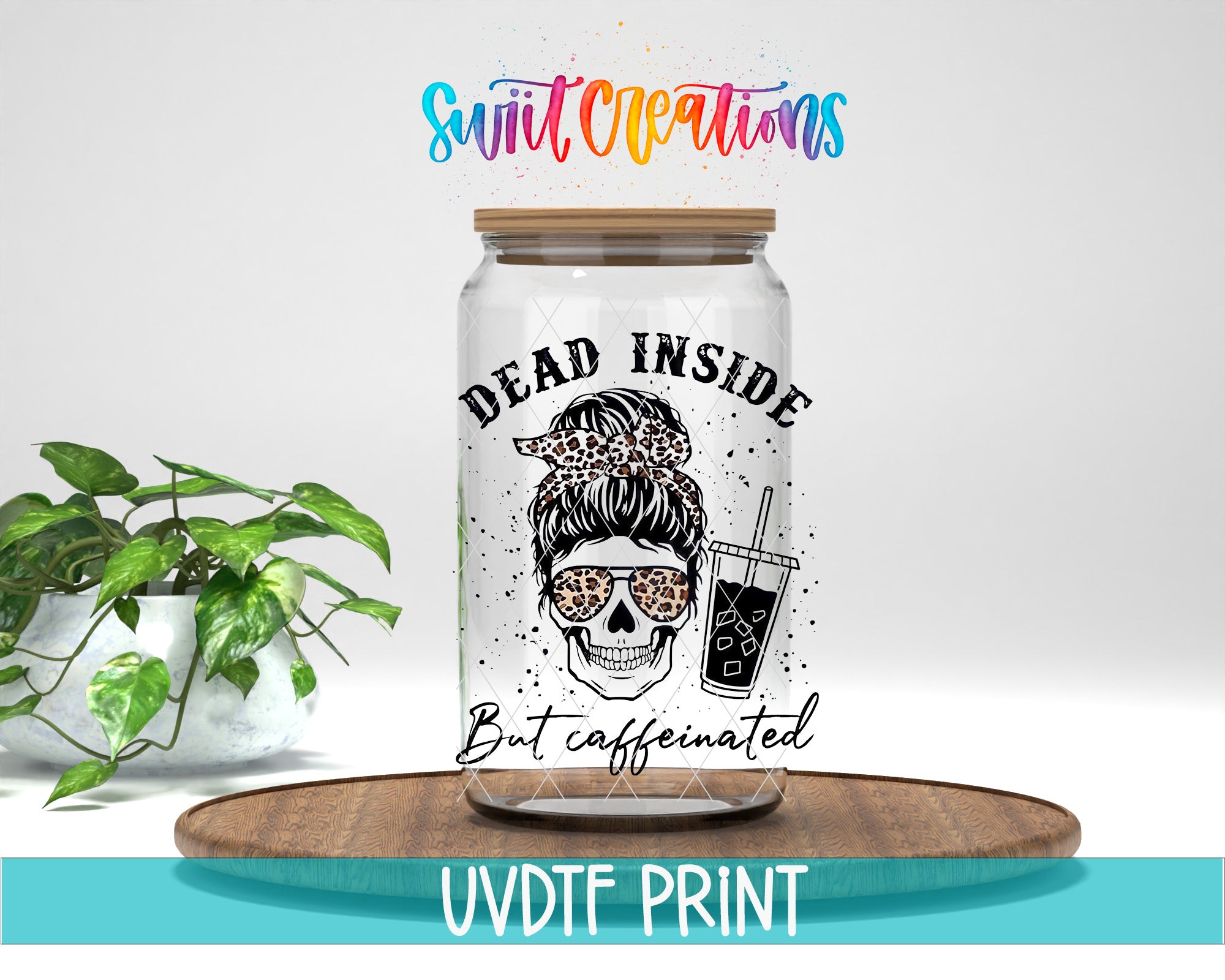 A glass jar with a leopard print design and the text "Dead inside but caffeinated" printed on it, placed on a wooden surface.