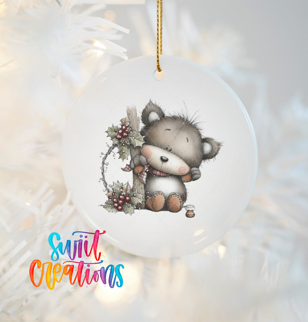 A ceramic ornament featuring a cute, furry bear sitting on a branch with berries, hanging on a string.