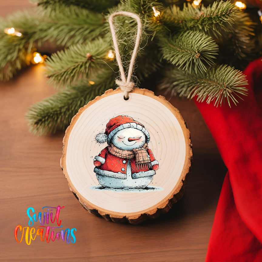 A wooden ornament featuring a smiling snowman is hanging on a Christmas tree, with a red cloth visible in the background.